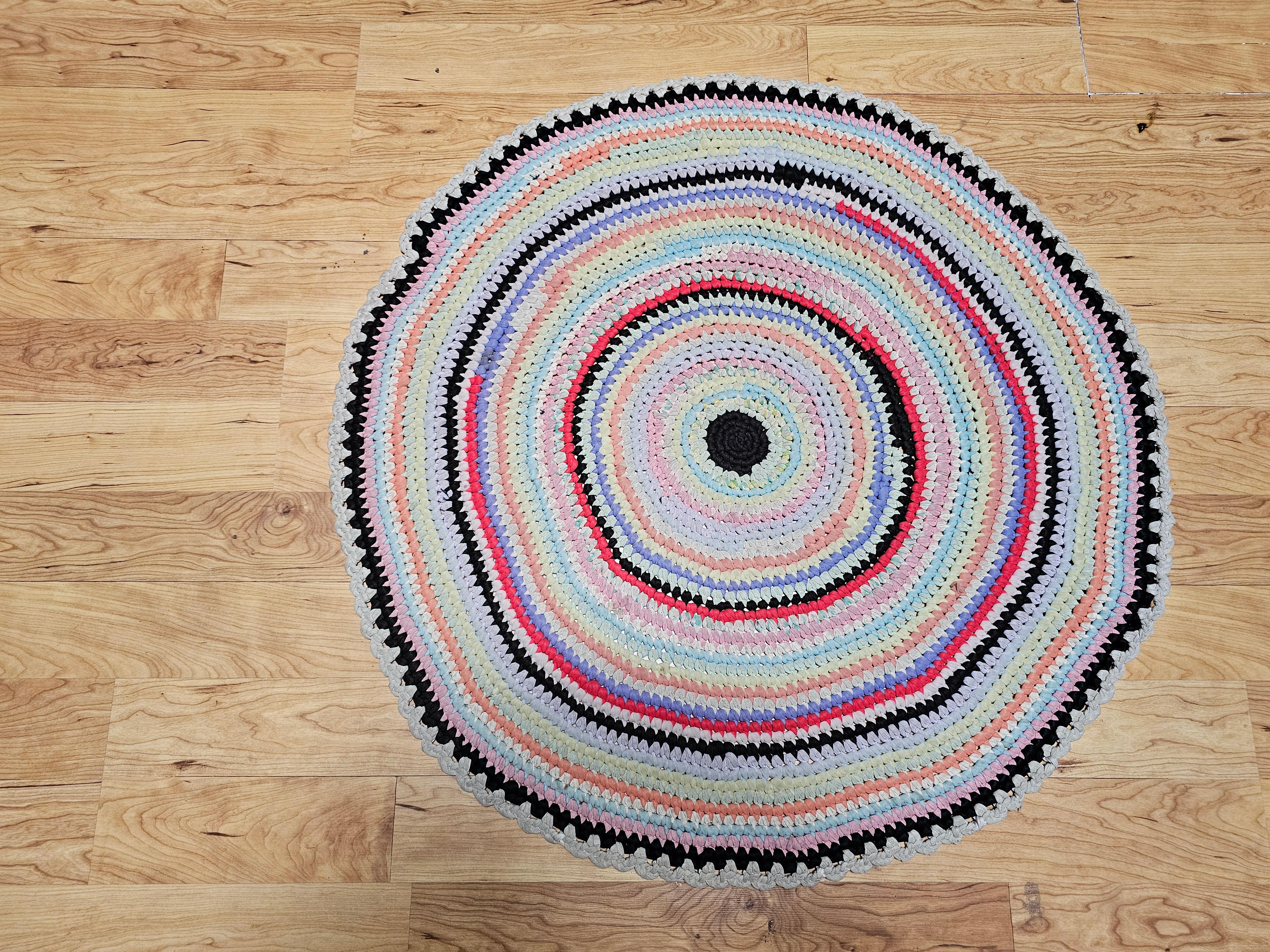 Antique American Braided Round area rug in blue, red, ivory, green from the 2nd quarter of the 1900s in Red, White, Blue, Yellow, Gray colors.  The rug design and colors are very lively and have a special beauty and vibrancy.  The rug is a best