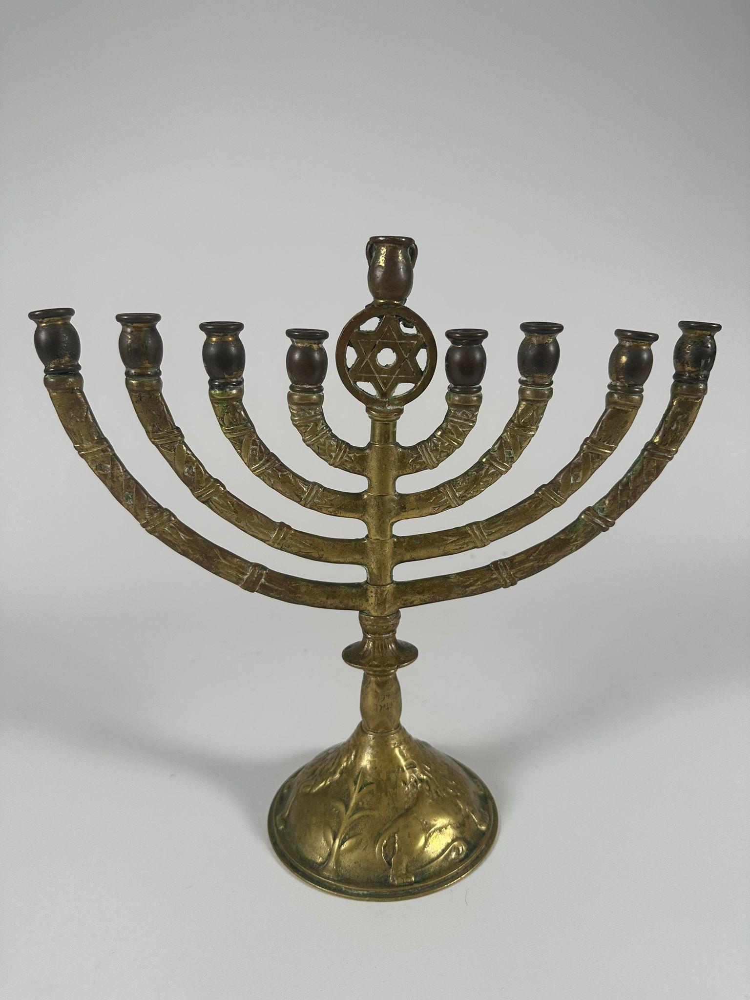 This brass Hanukkah menorah, made in the United States around 1920, was likely a promotional item for the Yiddish newspaper Der Tog (The Day), a widely read publication among Jewish immigrants in New York. Many Jewish newspapers at the time offered