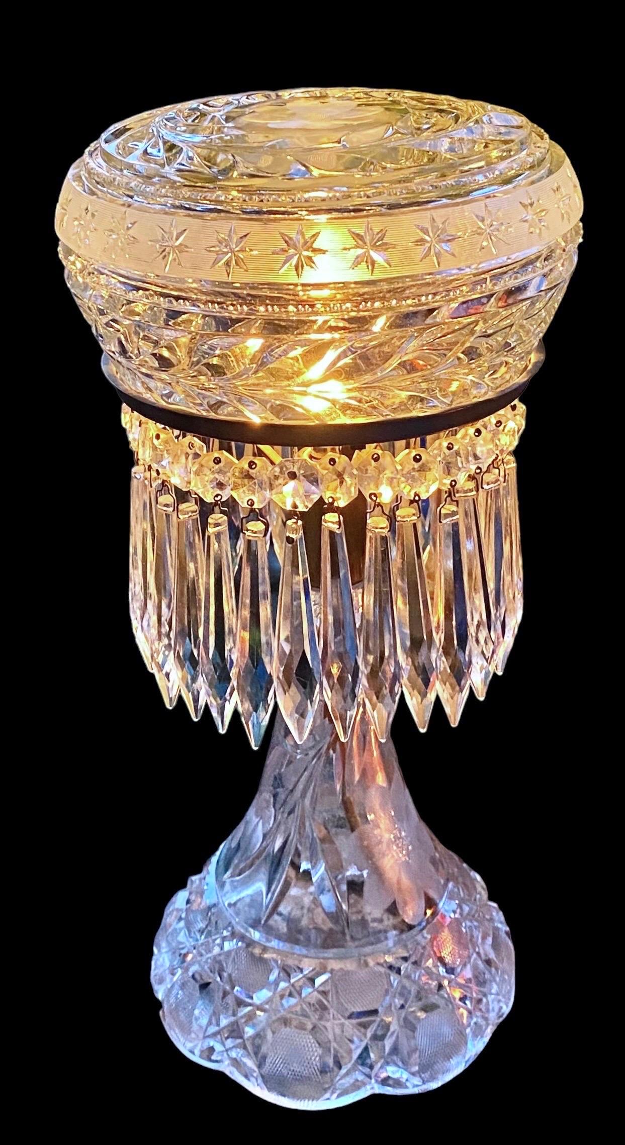 Elaborately cut American Brilliant glass table lamp. The base and shade are original with all around spear hanging crystals. The mount is silver plate and takes a chandelier base light bulb. The is 100% all hand cut and polished by a master cutter