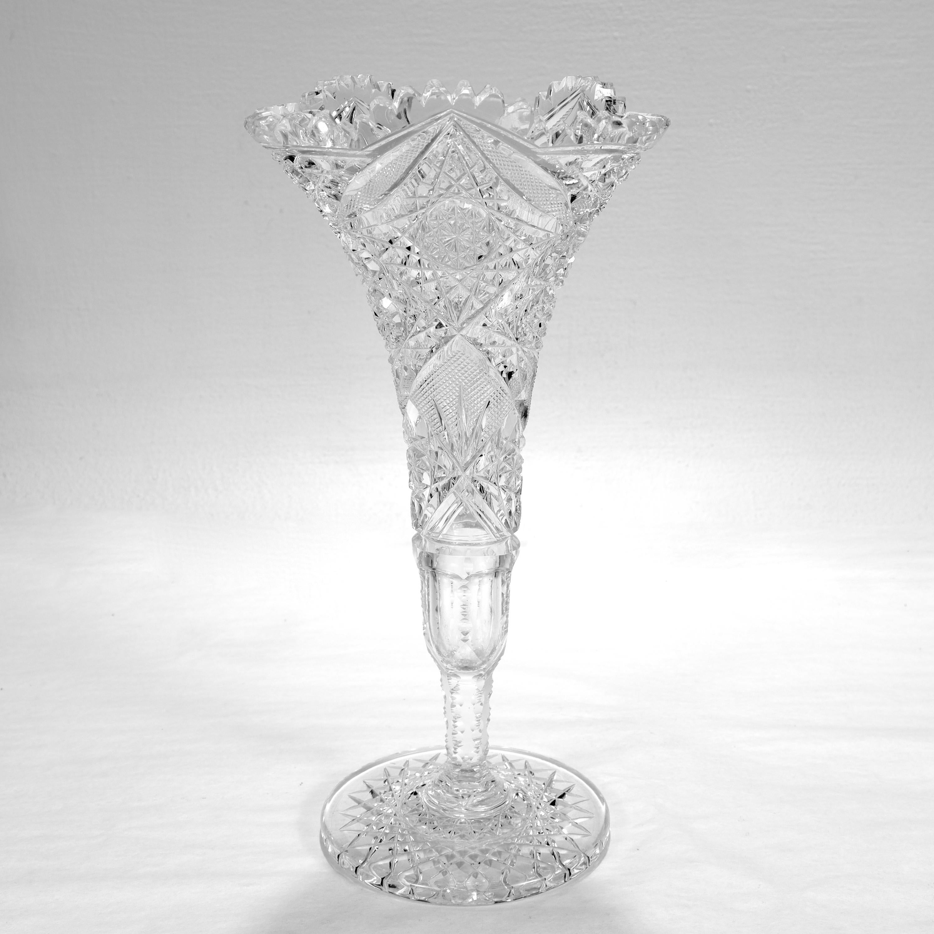 A fine antique American Brilliant Period cut glass vase.

In the form of a pedestal trumpet vase.

With a star pattern to the base, cut decorative patterns throughout, and a scalloped rim.

Simply a lovely American Brilliant Period
