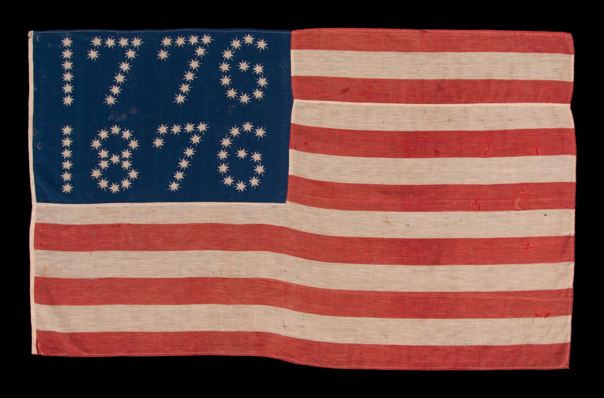 ANTIQUE AMERICAN FLAG WITH 10-POINTED STARS THAT SPELL “1776 – 1876”, MADE FOR THE 100-YEAR ANNIVERSARY OF AMERICAN INDEPENDENCE, ONE OF THE MOST GRAPHIC OF ALL EARLY EXAMPLES:

Many fantastic star patterns were made in the patriotism that