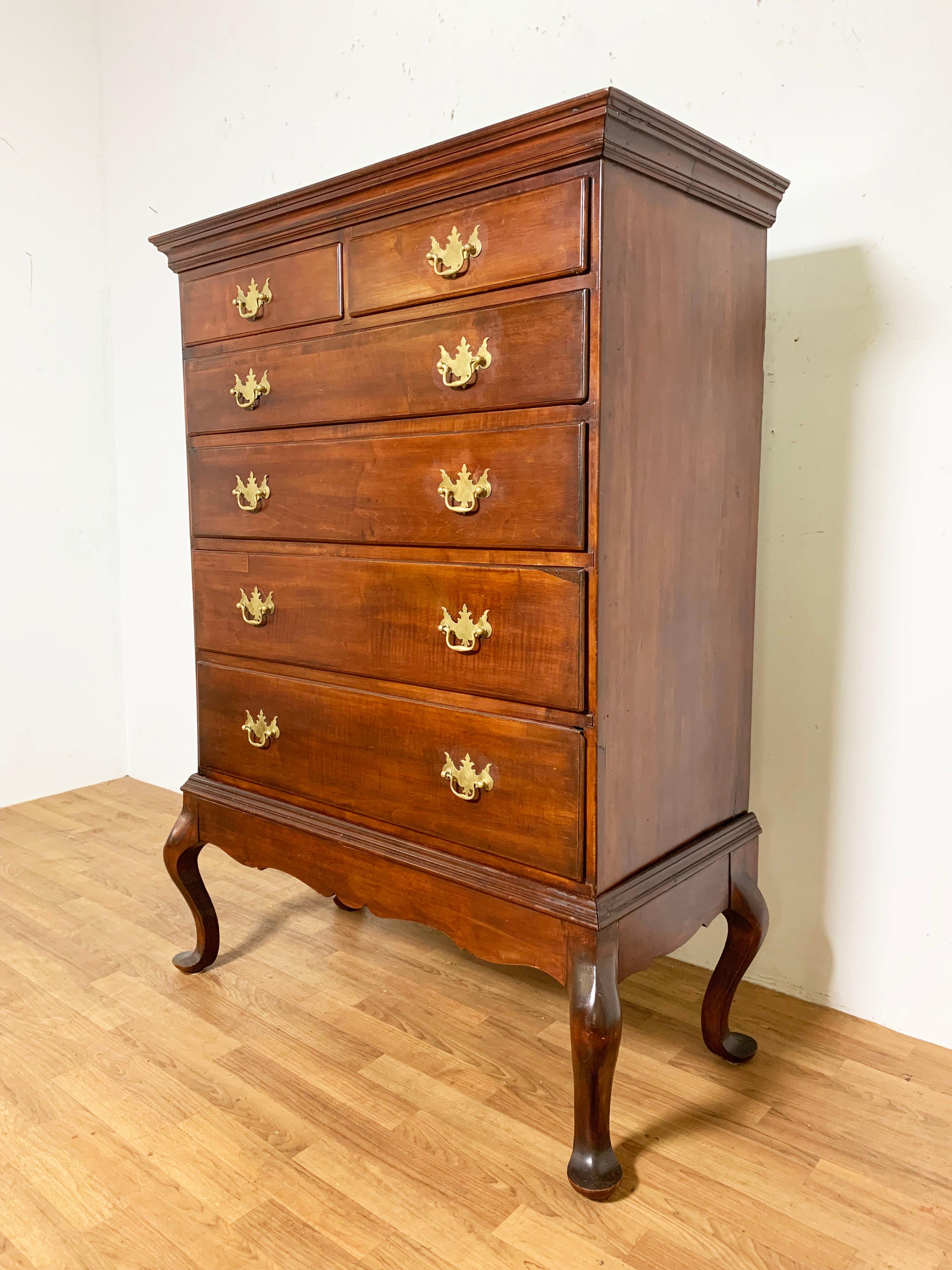 An American Chippendale chest on frame in cherry consisting of two drawer over four, the frame with carved skirt raised on cabriole legs with pad feet, Connecticut circa 1780.
      