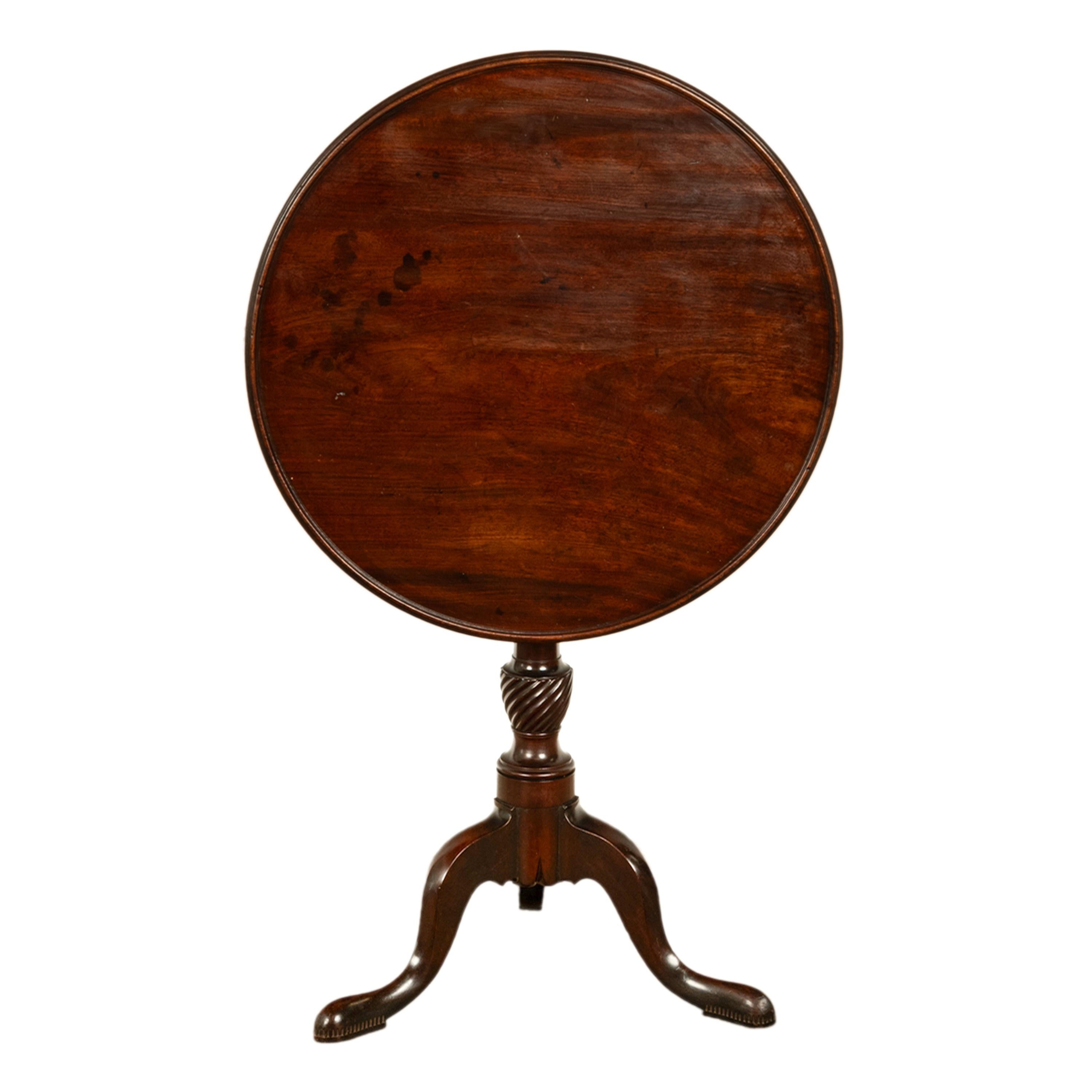 A good antique American Chippendale tilt-top mahogany table or candlestand, Philadelphia, circa 1770. 
The table having a circular 'dished' top that is also a tilt-top and locks into place with the original hand cut steel locking mechanism, the