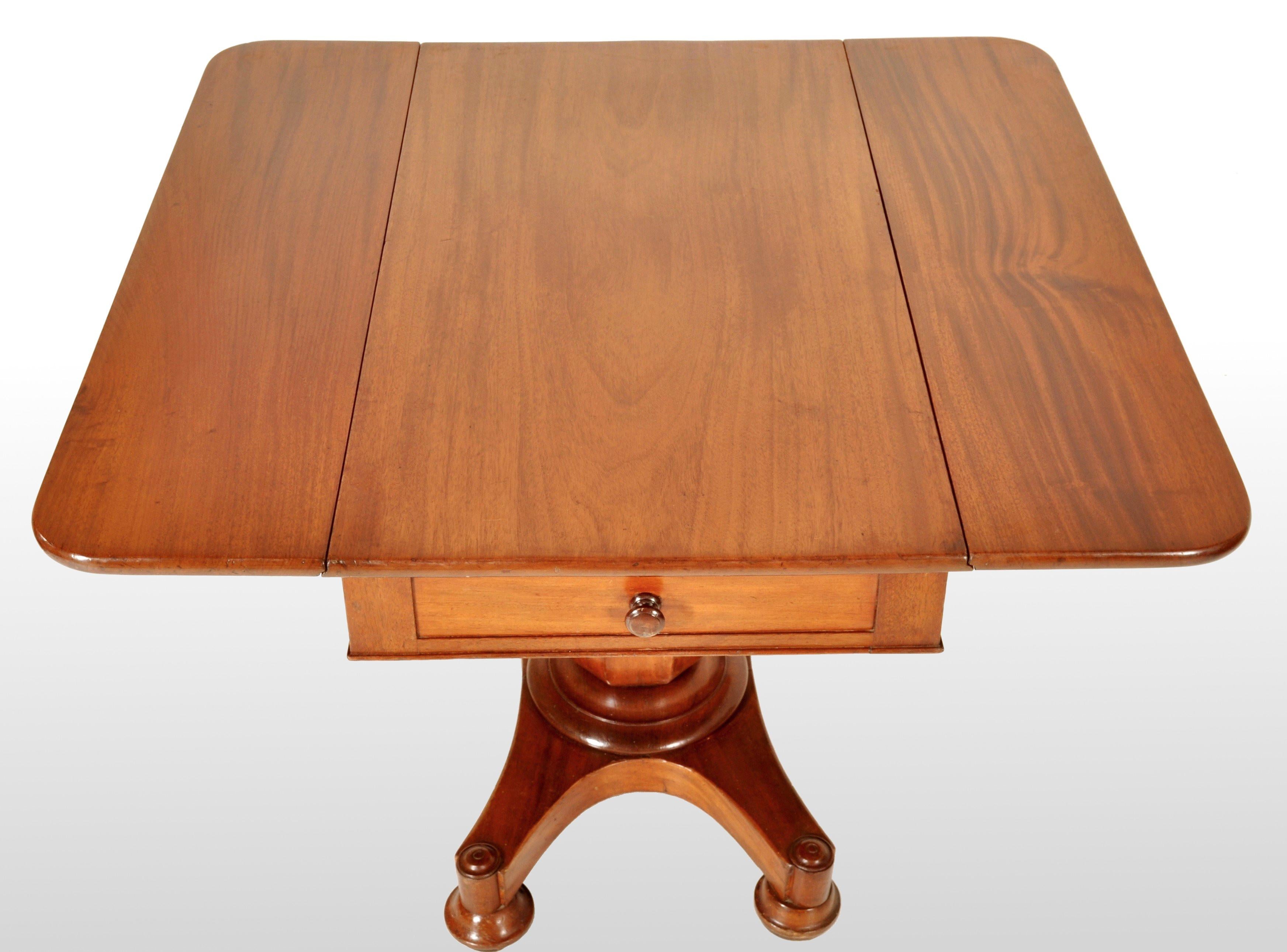Antique American classical mahogany drop leaf pedestal Pembroke table by John Needles of Baltimore, circa 1840. The table made of figured mahogany with twin drop leafs with a single drawer to the center. The table standing on a baluster shaped