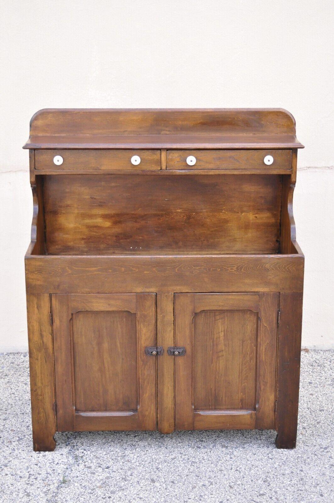 Antique American colonial primitive pine wood stepback drysink hutch cupboard. Item features a solid wood construction, beautiful wood grain, distressed finish, 2 swing doors, 2 drawers, very nice antique item, looks to have been professionally