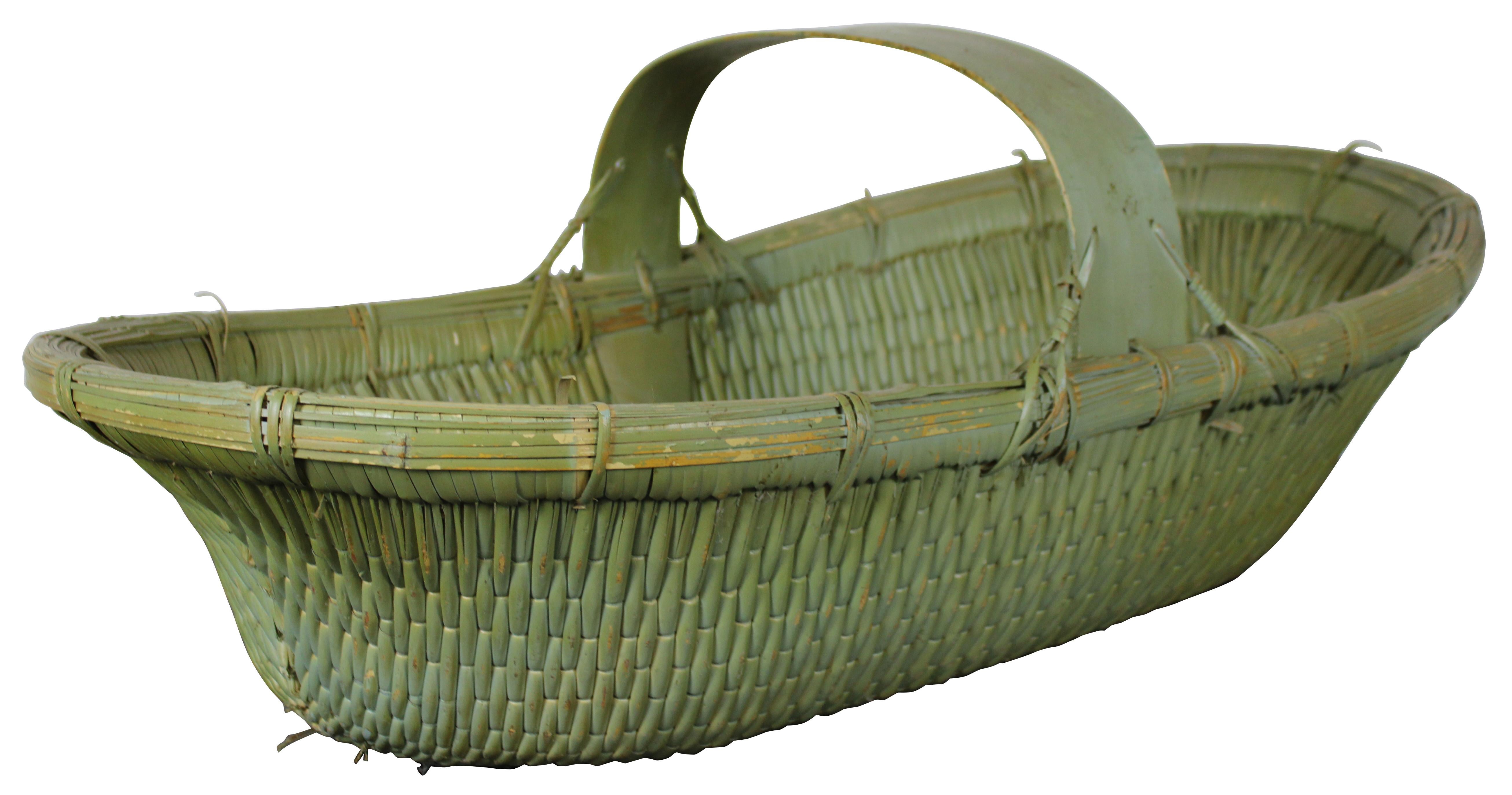 Large antique American country farmhouse oval shaped, green folk painted, tightly woven harvest or Moses basket with wide, sturdy handle. Measure: 37