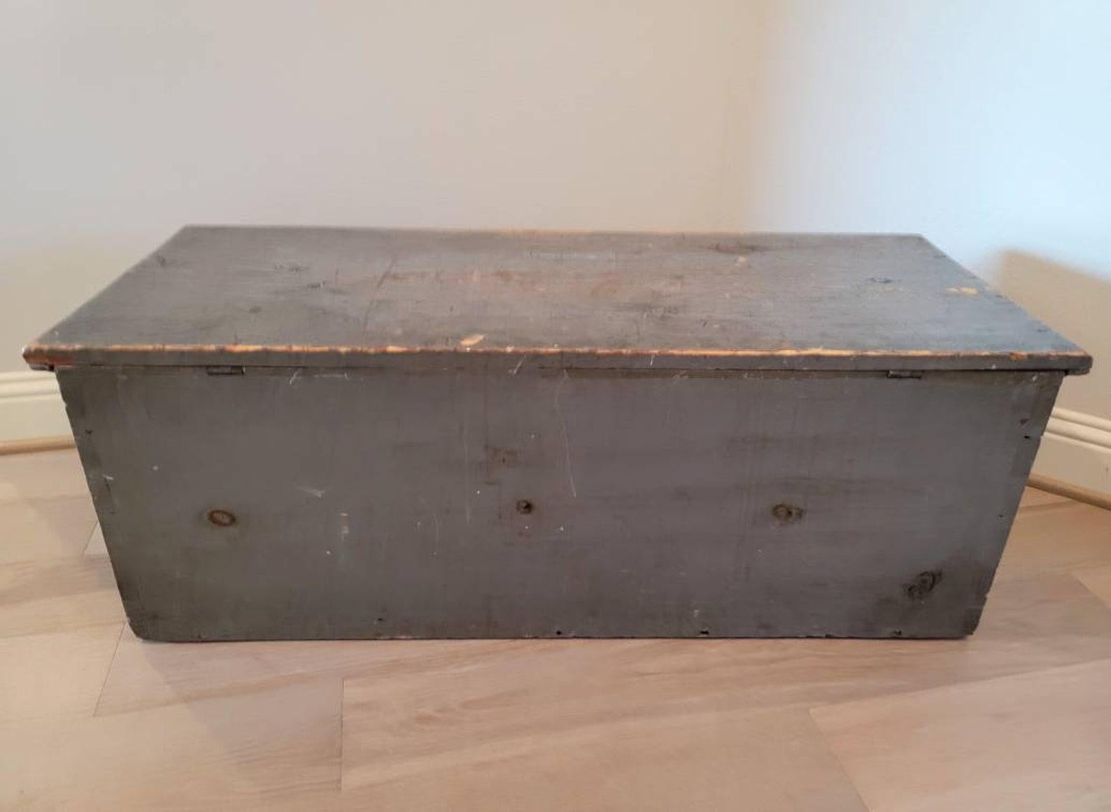 A large pine blanket chest in original slate blue / gray paint with remarkable aged distressed patina finish, hammered iron hinges, and dovetail corners.

Born in the Northeastern United States (most likey New England region) during the first half