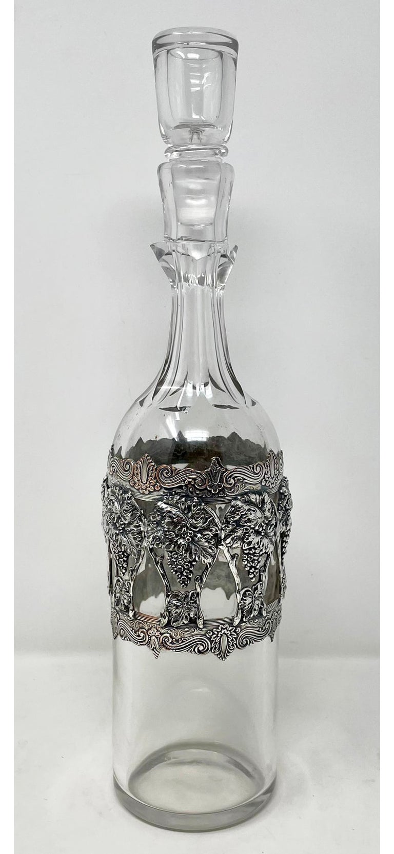 Antique American cut crystal wine decanter with sterling silver grape design overlay, Circa 1900. Per the final photograph, we currently have 2 of these decanters, each listed and sold individually. The decanter shown here is on the left in the last