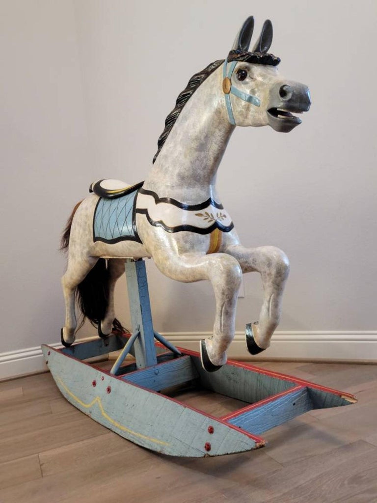 An antique American track machine carousel horse attributed to legendary carver Charles W. Dare Company, now mounted as a rocking horse.

Hand-crafted in the early 20th century, circa 1920, born during the Golden Age of carousels in America (circa