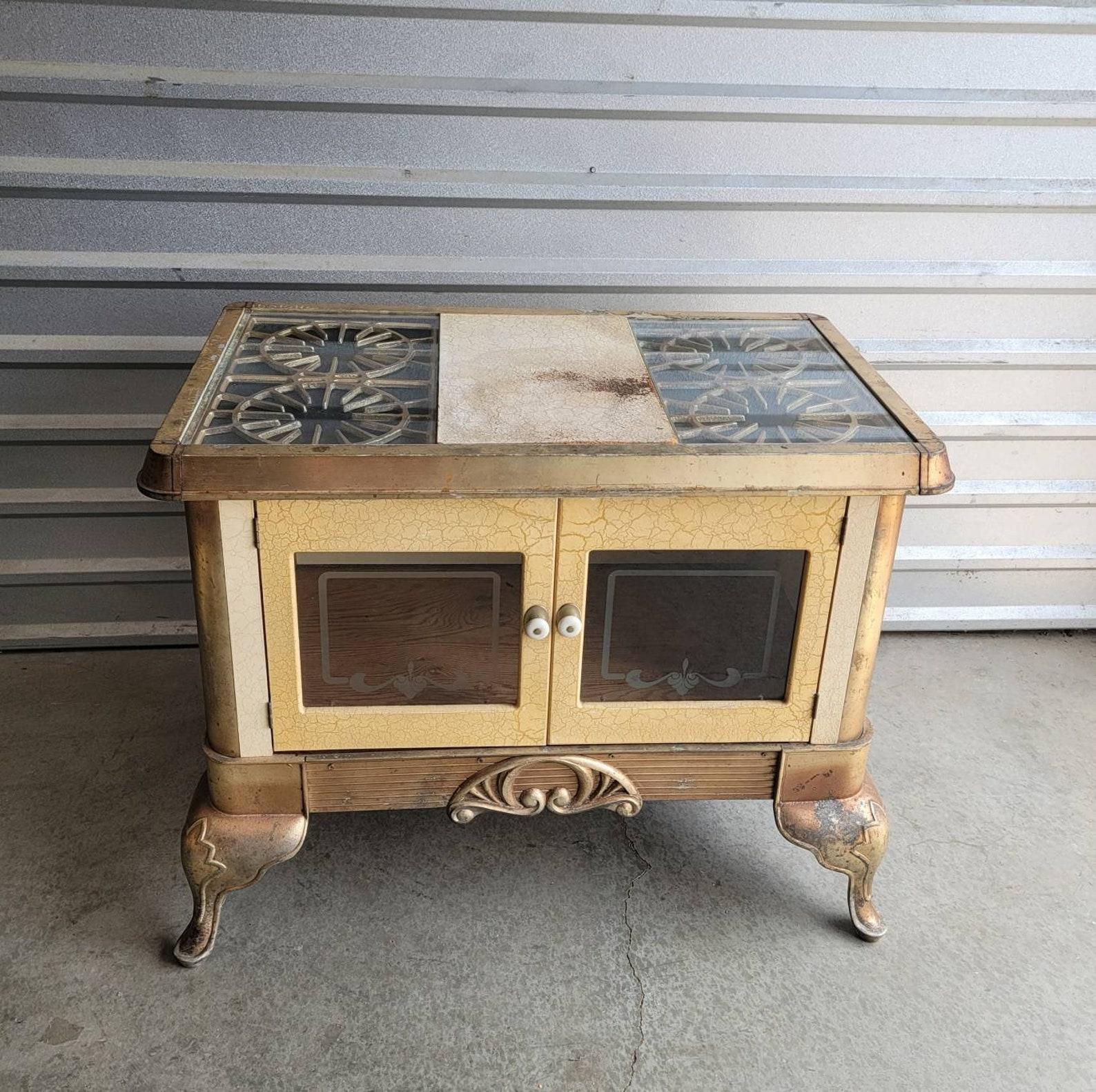 A charming antique American kitchen range warming oven wood stove converted into a unique table with lots of storage!

Born around the turn of the late 19th / early 20th century, repurposed and fashioned it a one-of-a-kind table (or kitchen