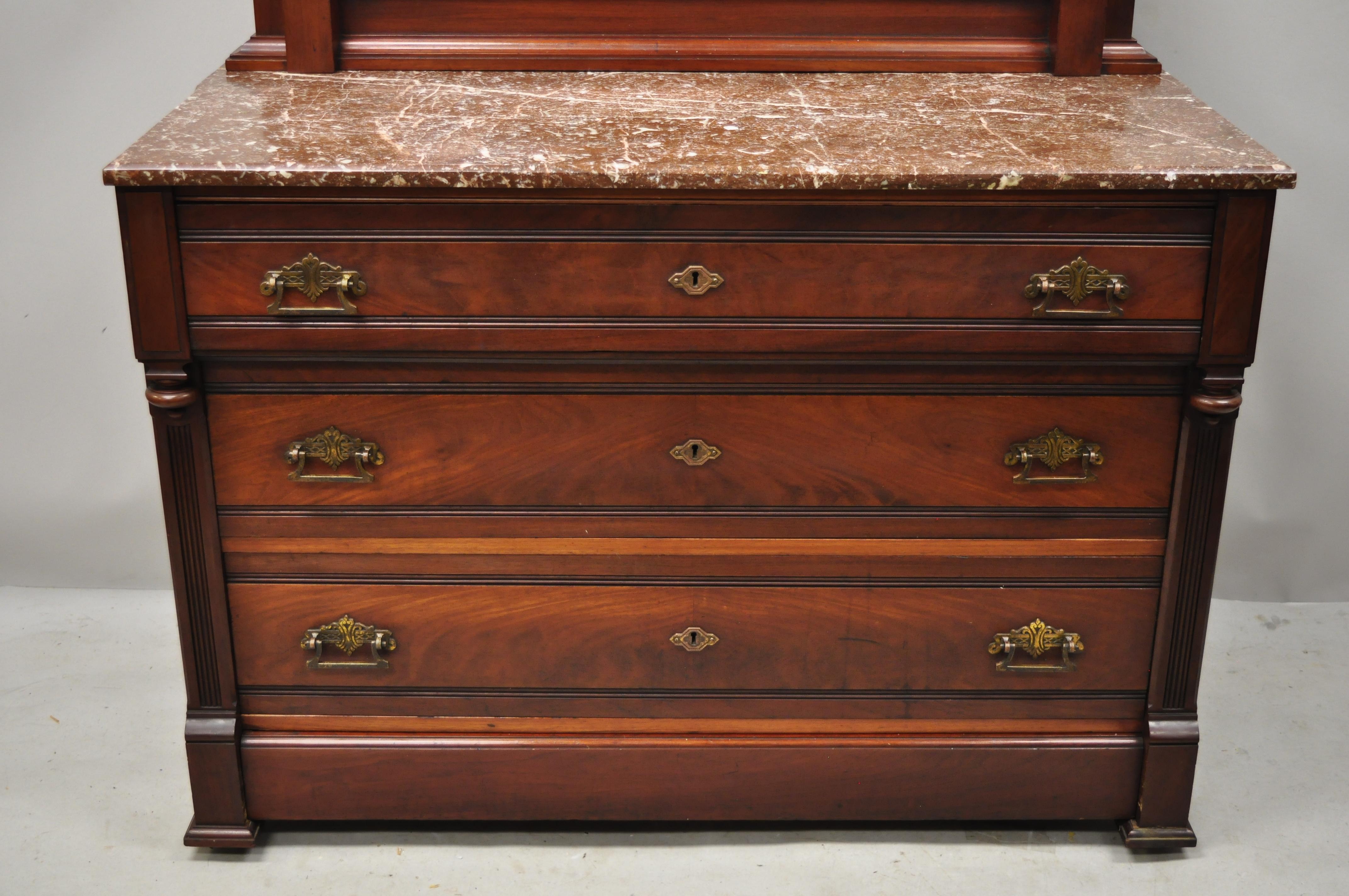Antique American Eastlake Victorian marble-top walnut washstand dresser with mirror. Item features a marble-top, hidden lower drawer, hidden side drawer, solid wood construction, beautiful wood grain, nicely carved details, no key, but unlocked, 5