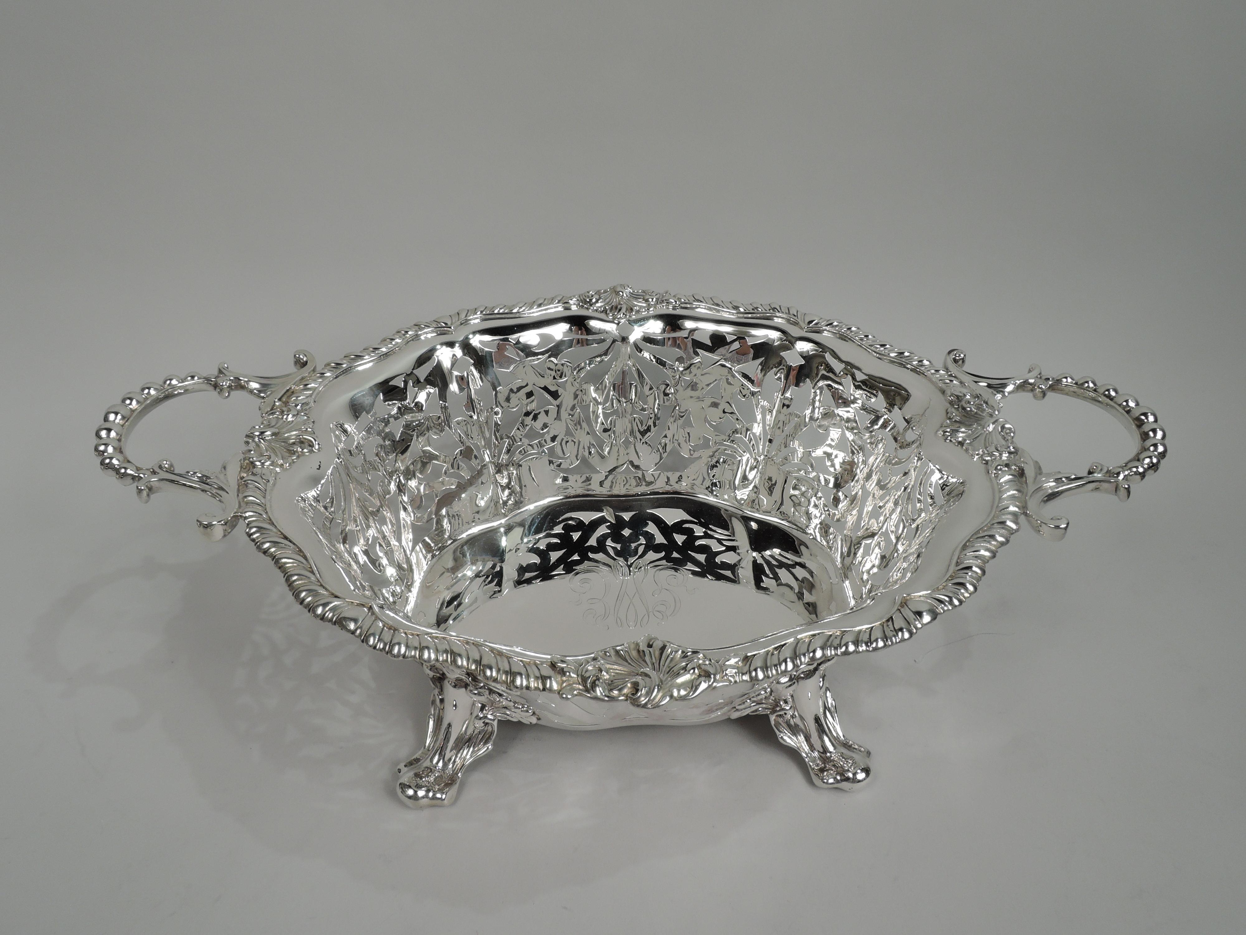 Edwardian Classical sterling silver bowl. Made by Shreve, Crump & Low Co. in Boston, ca 1890. Solid and shaped well lobed and tapering sides with leafing, flowering, and scrolling openwork. Gadrooned serpentine rim interspersed with scallop shells.
