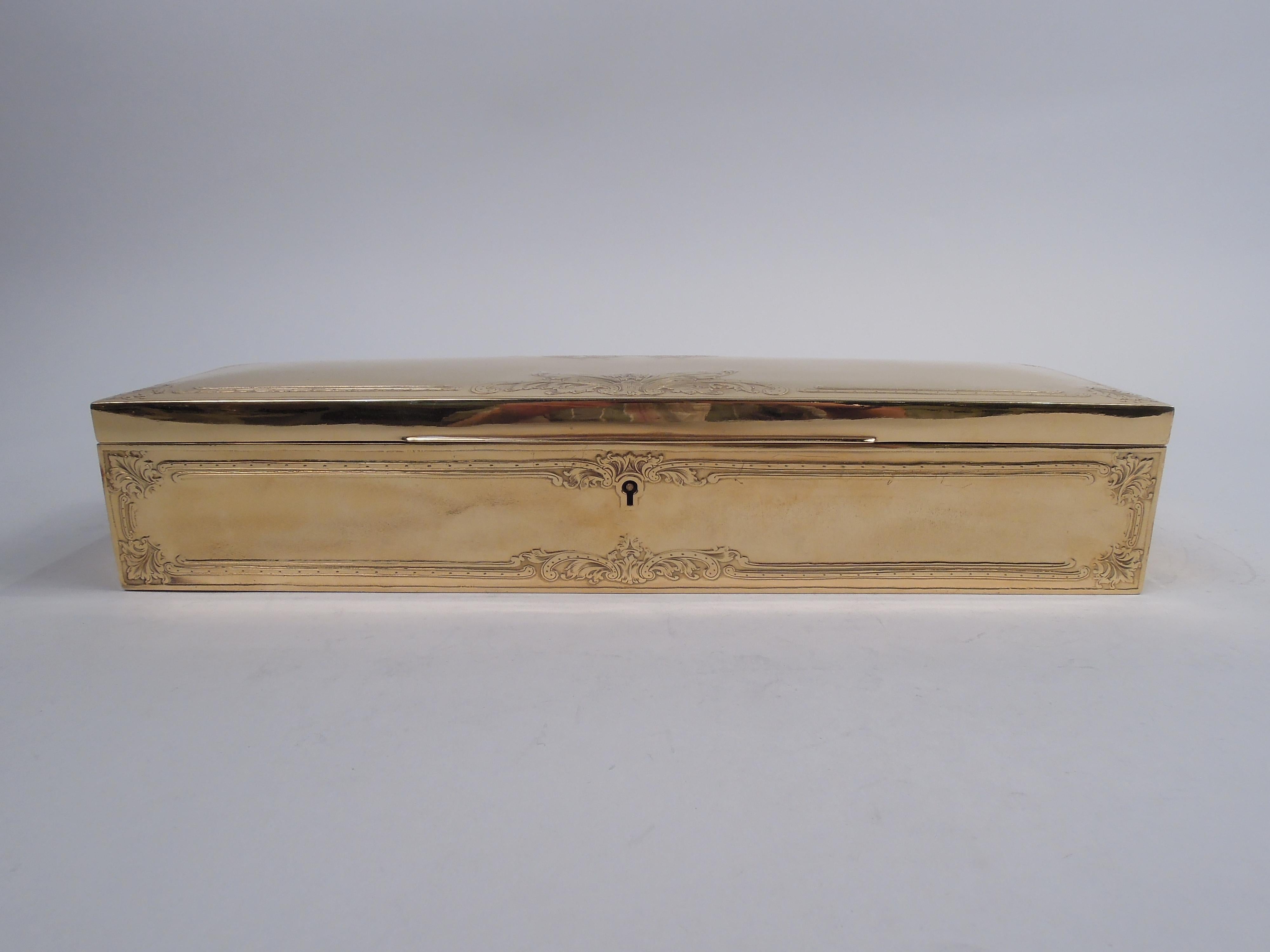 Edwardian Classical gilt sterling silver glove box. Made by Ahrendt & Kautzman in Newark, ca 1910. Rectangular with straight sides and sharp corners. Cover hinged with tapering tab and gently curved top. Low-relief ornament in form of rectilinear
