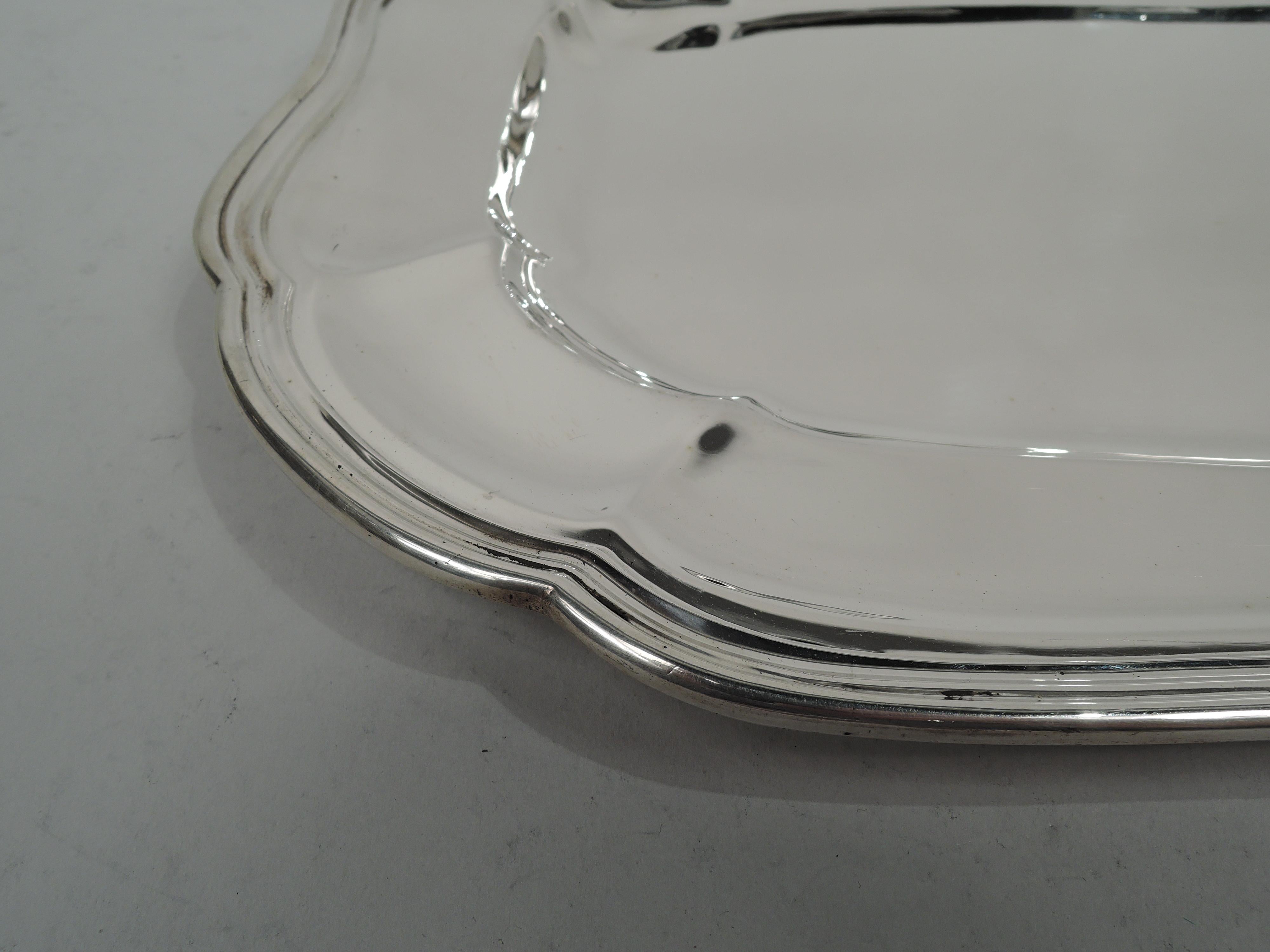 American Edwardian Classical sterling silver tray, ca 1910. Rectangular well with curved corners, tapering and paneled shoulder, and molded serpentine rim. Fully marked including retailer’s stamp (Bailey, Banks & Biddle) and no. 1088. Heavy weight: