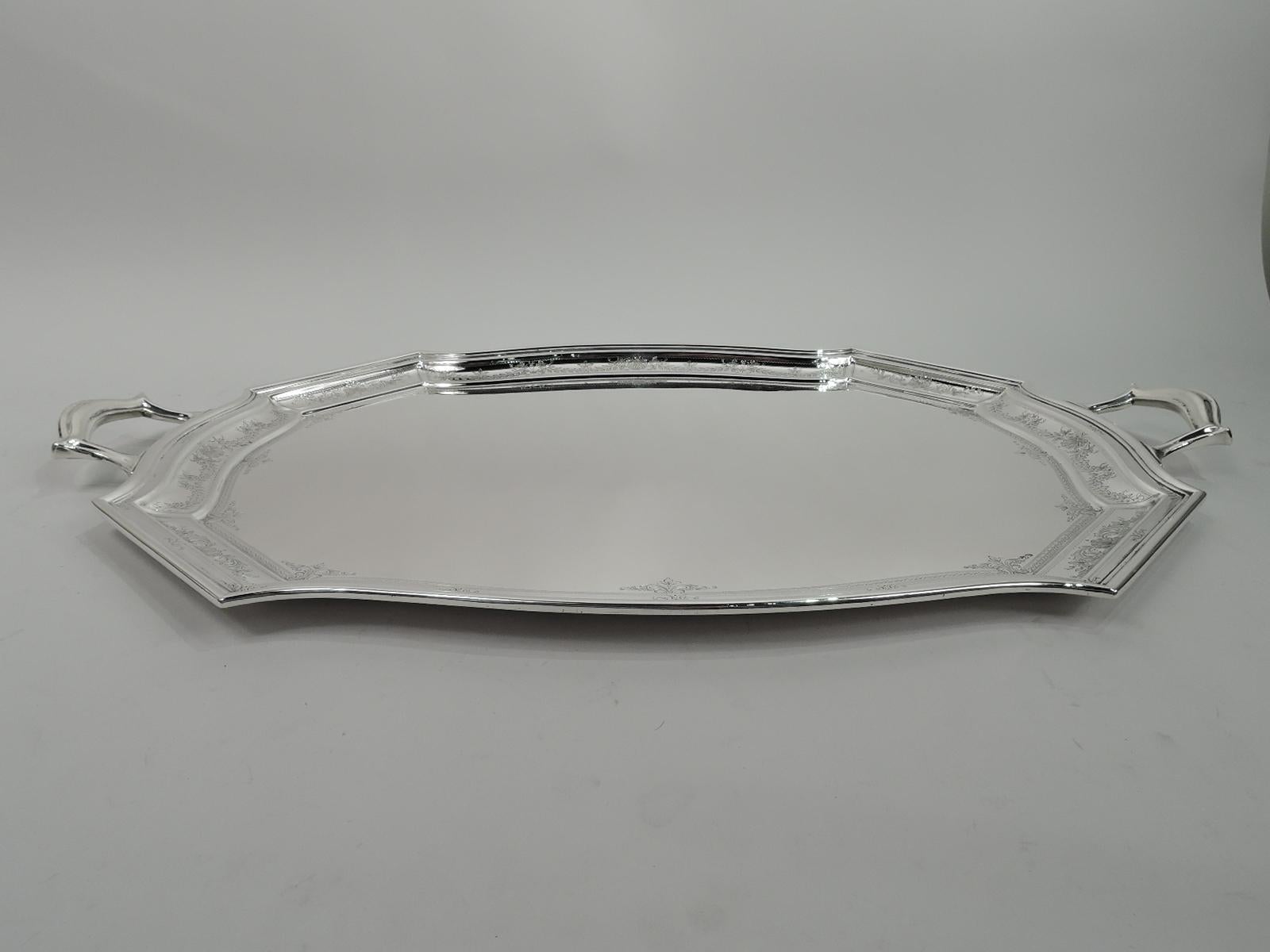 Edwardian Regency sterling silver tea tray. Made by William B. Durgin (part of Gorham) in Concord, New Hampshire, ca 1920. Shaped well with curved sides and chamfered corners. Tapering shoulder and molded rim. Scroll bracket handles mounted to ends.