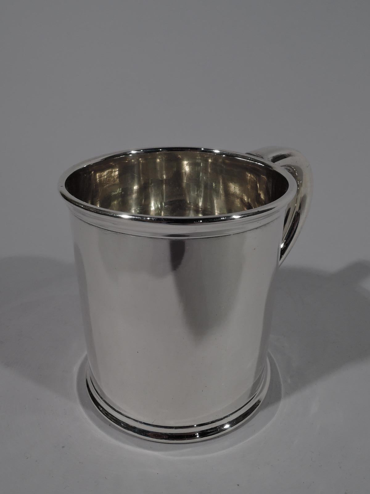 Edwardian sterling silver baby cup. Retailed by JE Caldwell in Philadelphia, circa 1910. Straight sides, molded rim and base, and C-scroll handle. Lots of room for engraving. Fully marked including retailer’s stamp and no. 863. Weight: 3 troy ounces.