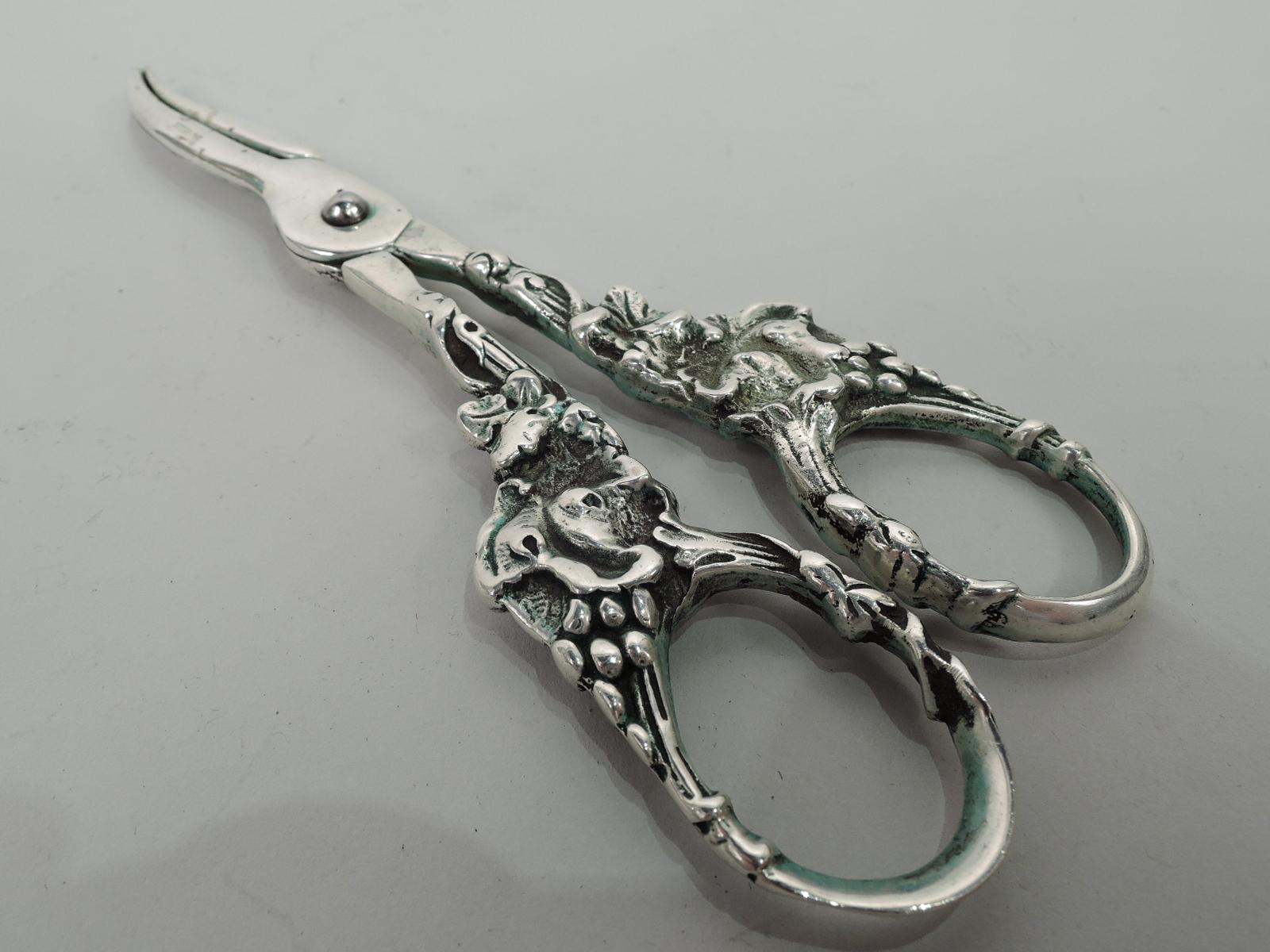 American Edwardian sterling silver grape shears, ca 1910. Ring handles in form of fruiting grapevine. Marked “Sterling”. Weight: 3.3 troy ounces.