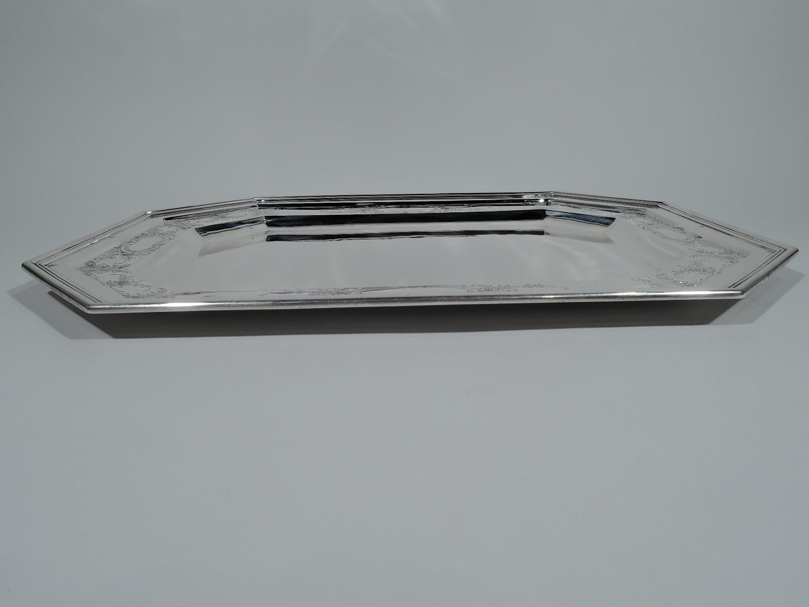 Edwardian sterling silver serving tray. Made by Durgin (part of Gorham), circa 1910. Rectangular with chamfered corners and reeded rim. Engraved leaf-and-scroll border with scrolled frames (vacant). Fully marked including Durgin and Gorham stamps