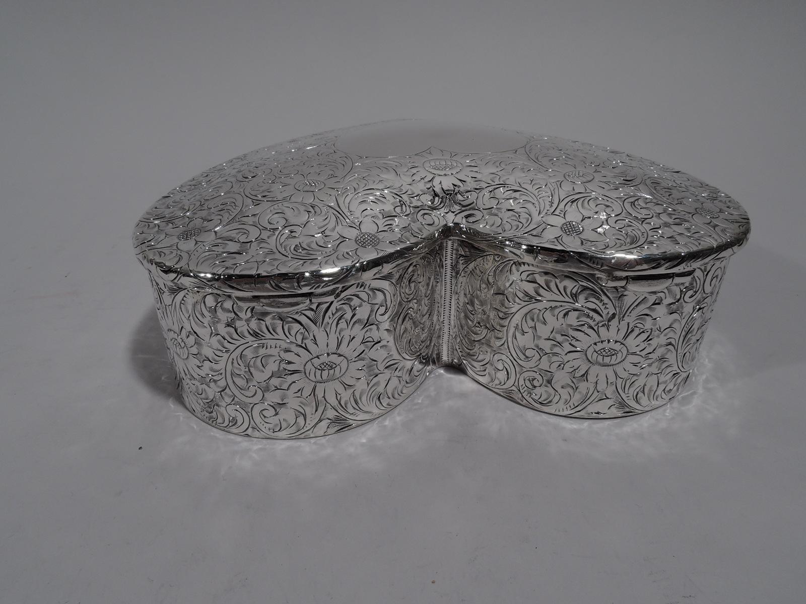 American Edwardian sterling silver jewelry box. Heart-form. Cover hinged and gently raised. Dense all-over engraved flowers including daisies. Turn-of-the-century flower power to convey a special message. Cover has vacant cartouche for spelling it