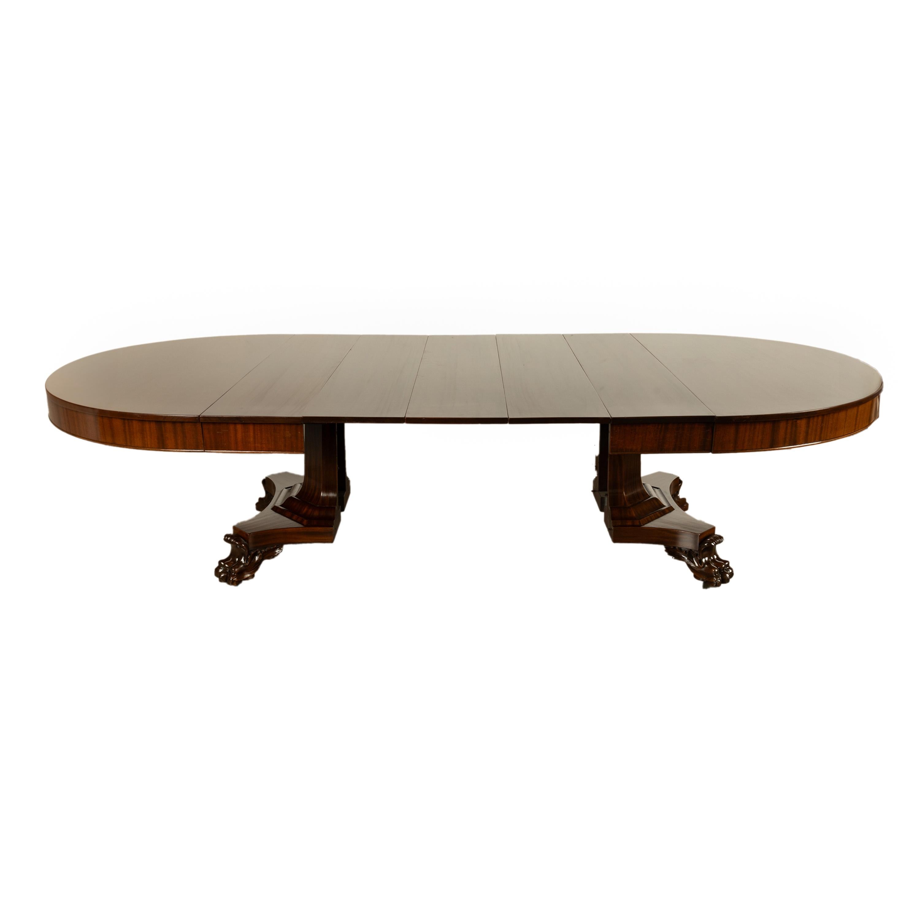 A fine antique American Empire mahogany dining table with five leaves, circa 1830.
Without leaves inserted the pedestal table is circular with a 60