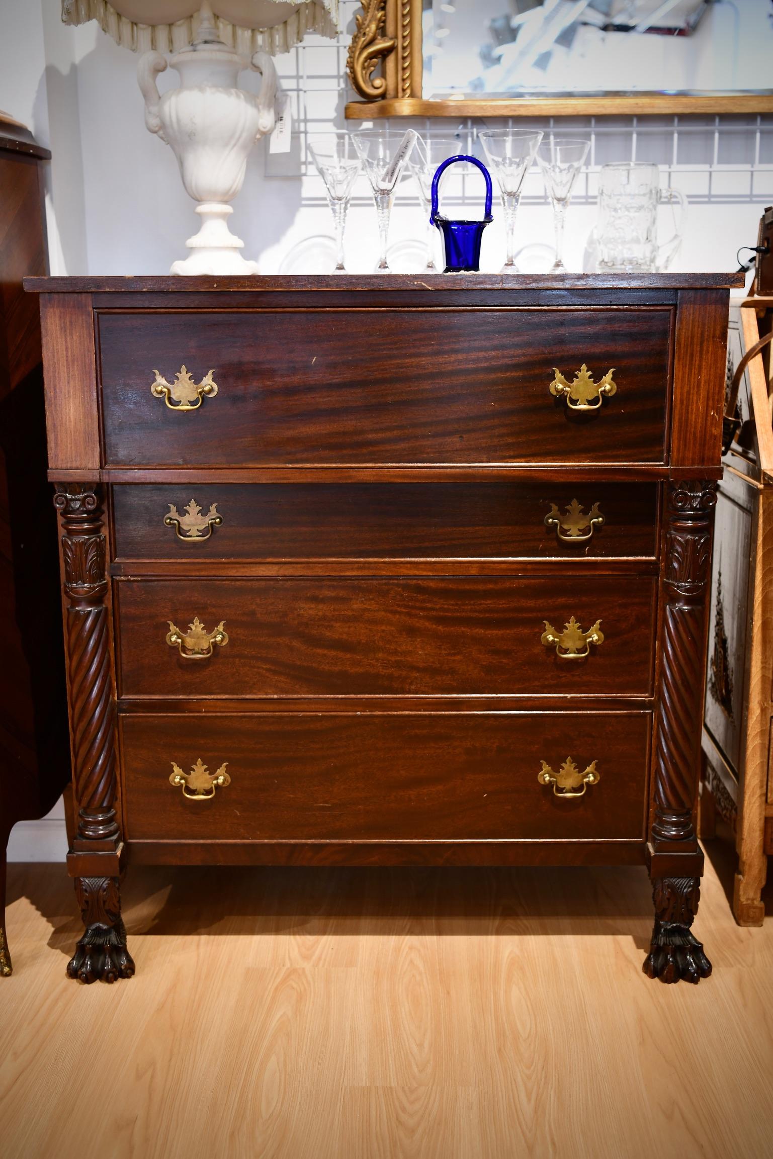 Antique American empire bachelor's chest of drawers. Top drawer folds down to become a desk. Dimensions: 43.5