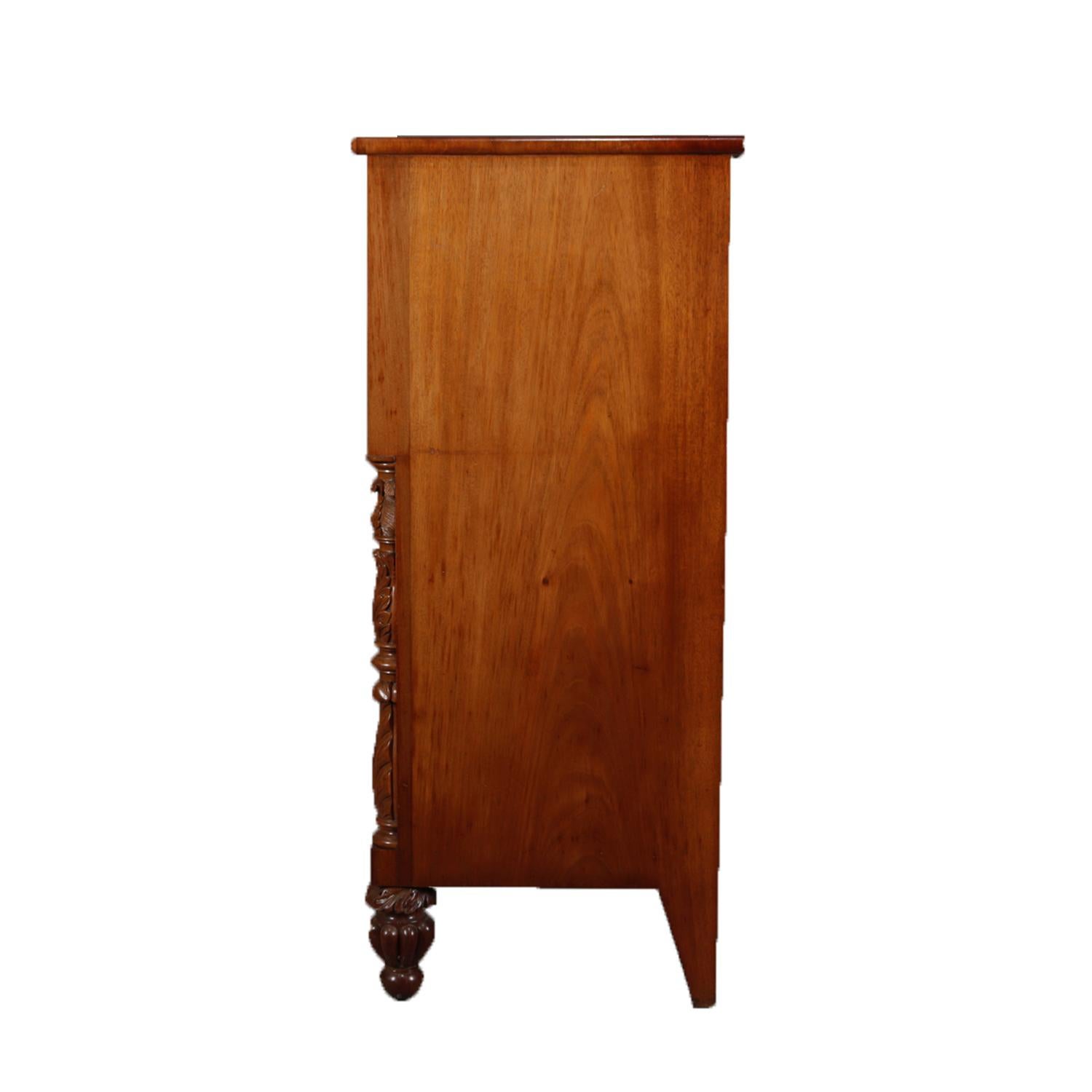 An antique American Empire Jackson linen press features mahogany construction with flame mahogany cabinet having two smaller upper drawers over a long and deep single drawer which surmounts double doors opening to storage cabinet and flanked by