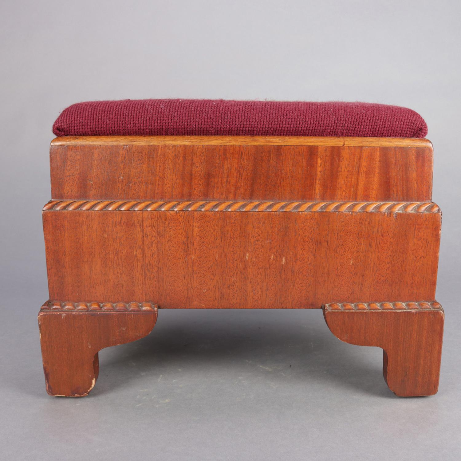 Antique American Empire footstool features mahogany construction in stepped form with carved rope twist trimming, needlepoint upholstered seat with central rose floral spray, and raised on ogee feet, 20th century.


Measures: 12