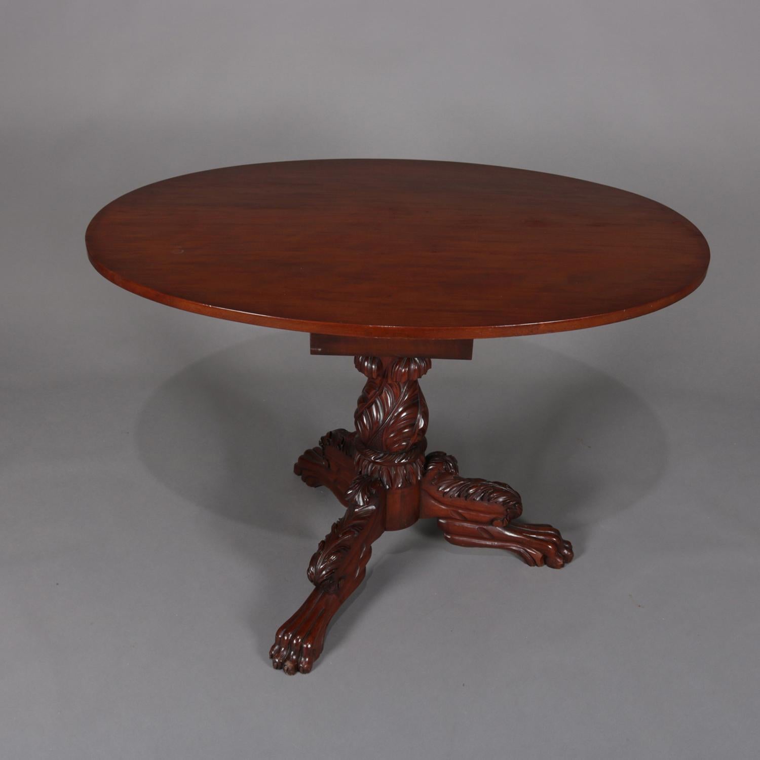 American Empire tilt-top table features mahogany construction with oval tilt top over bird cage and latch system supported by carved acanthus plinth with three intricately carved legs with paw feet, circa 1840

Measures: 54.5