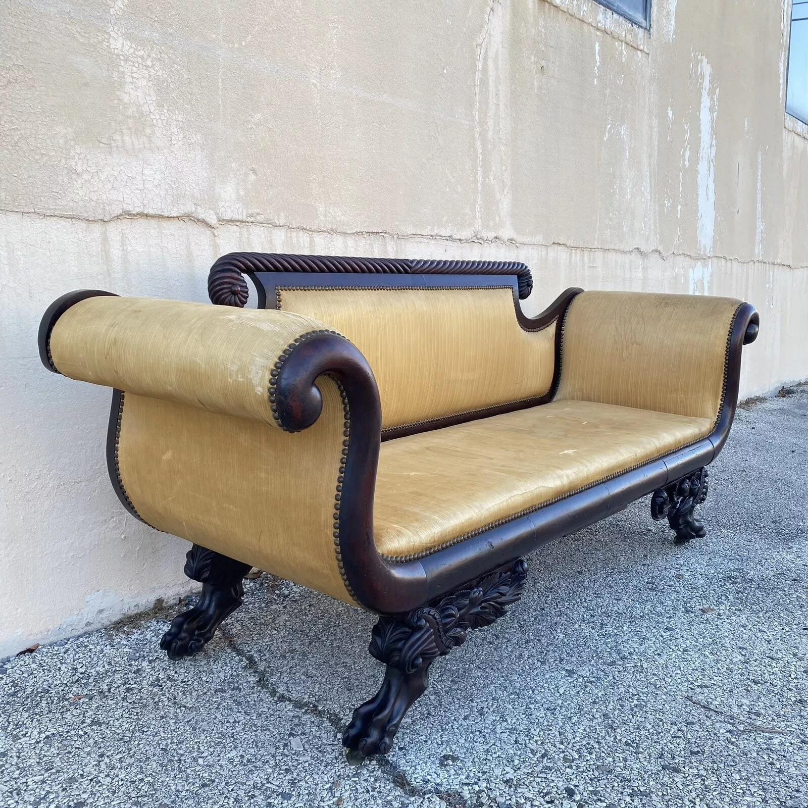 Antique American Empire Classical Carved Mahogany Paw Foot Rolled Arm Sofa. Item features carved paw feet with cornucopia carvings, spiral carved top rail, great antique sofa to reupholster. Retains 