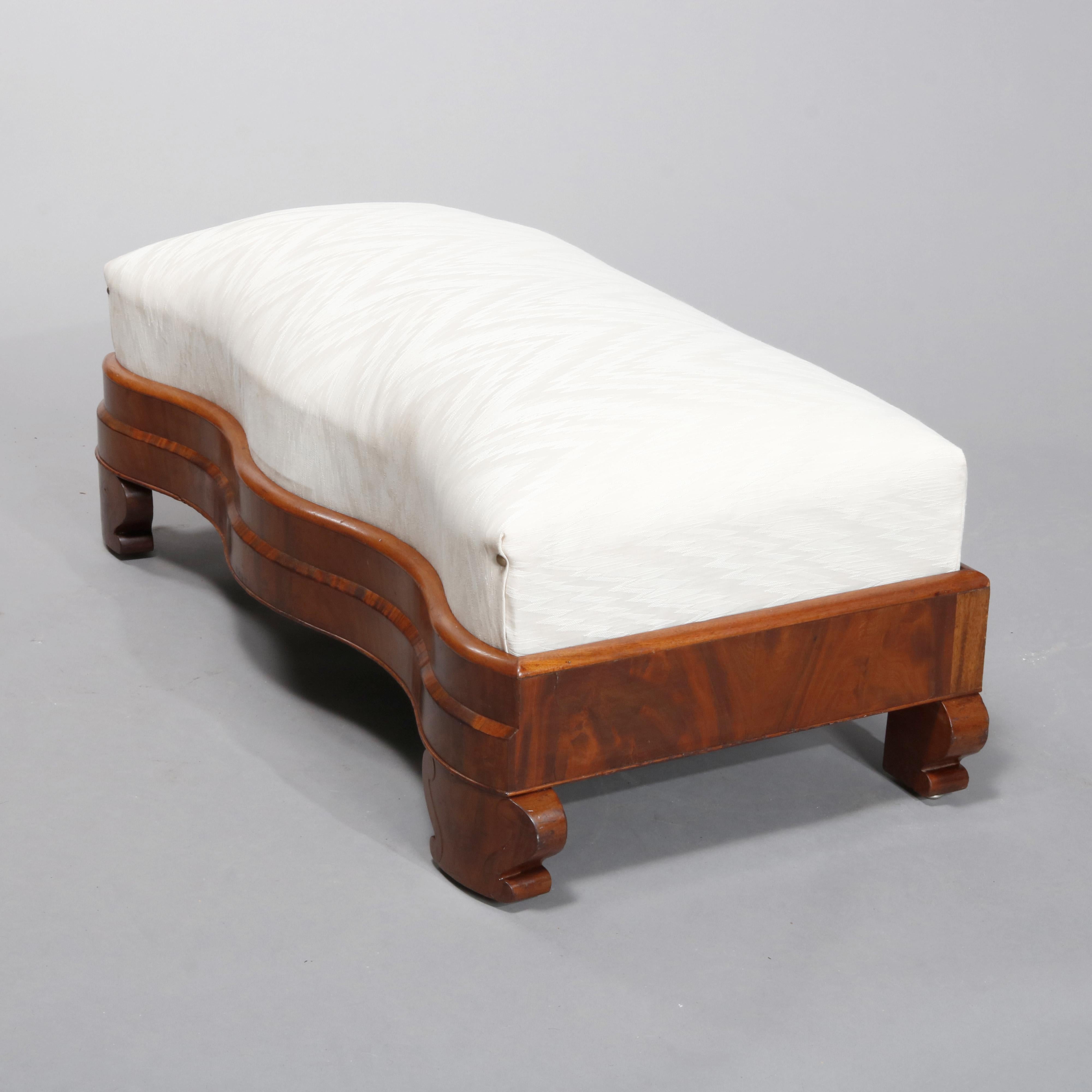An antique American Empire classical slipper bench offers upholstered seat over serpentine flame mahogany frame raised on urn form feet, circa 1840

Measures: 14.75