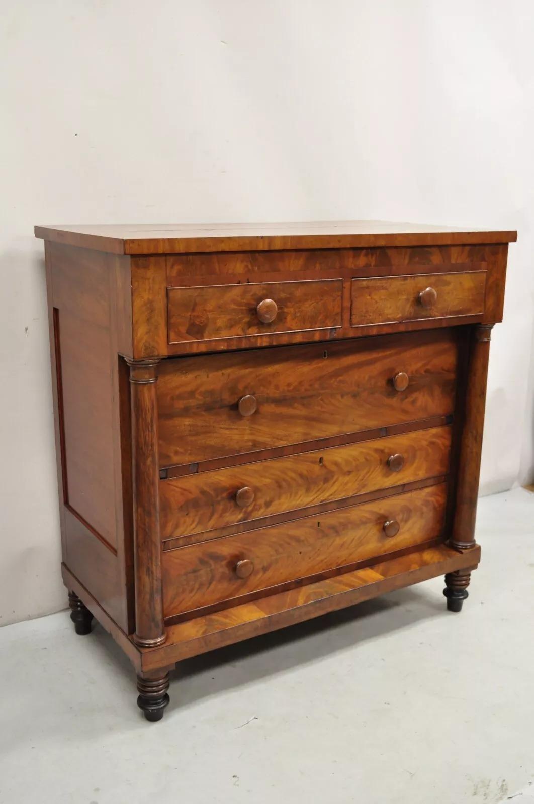 Antique American Empire Crotch Mahogany 5 Drawer Highboy Tall Chest Dresser. Item features five hand dovetailed drawers, turn carved legs, beautiful wood grain, very nice antique chest. Circa Mid 19th Century. Measurements: 44
