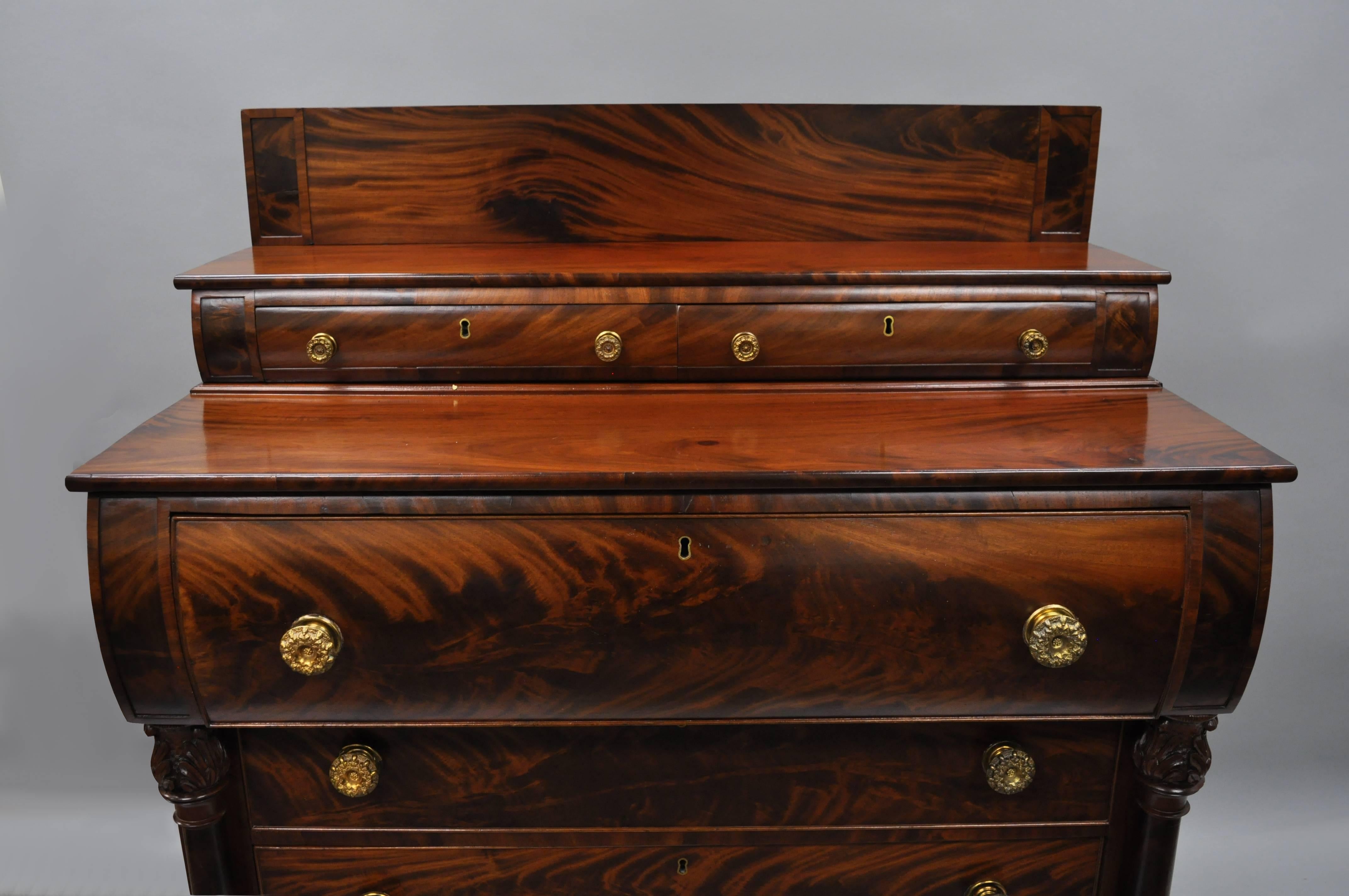 Antique American Empire crotch mahogany chest of drawers with paw feet, circa early to mid-1800s. Item features stunning crotch mahogany wood veneer, six drawers, carved paw feet, column supports, brass pulls, no key but unlocked, original owners