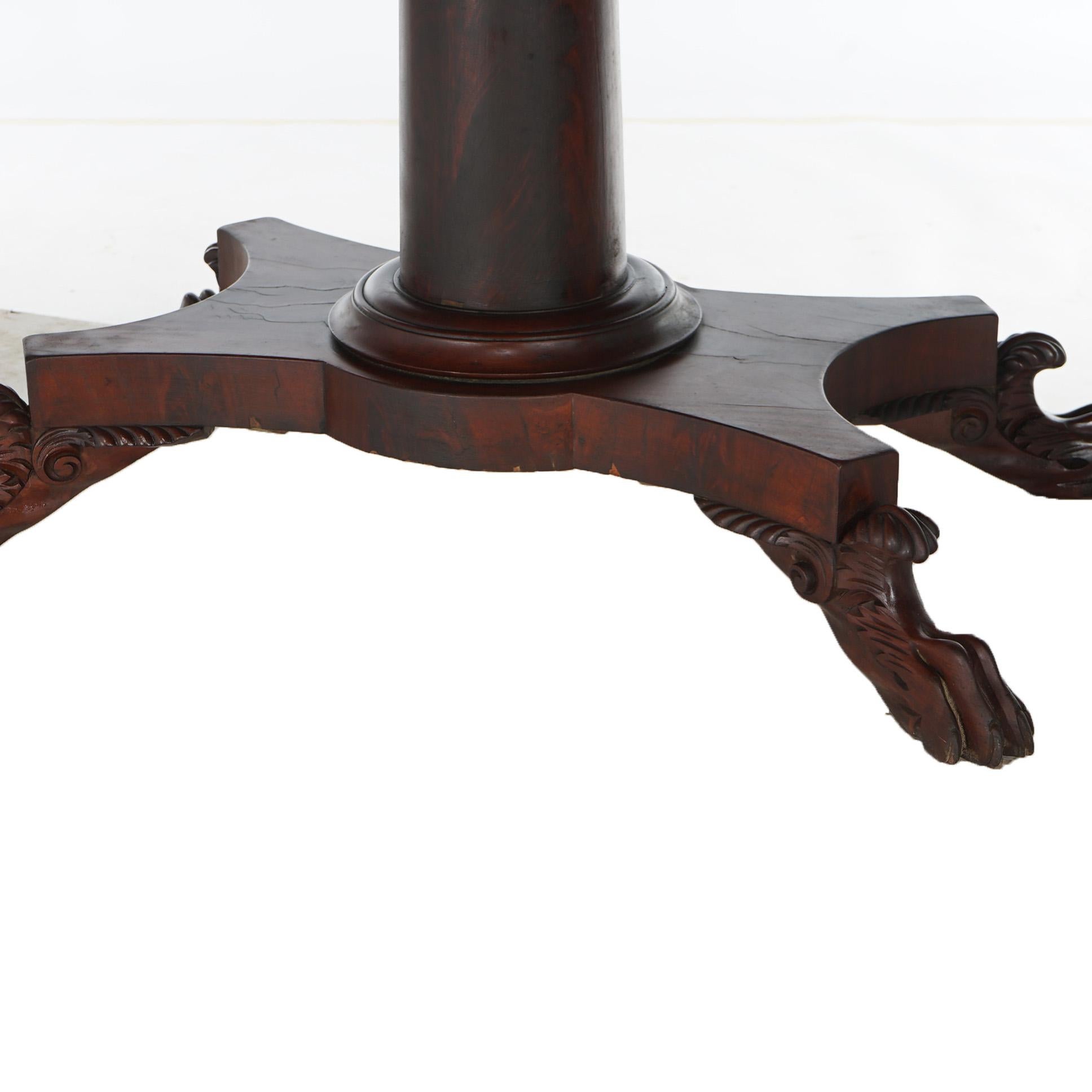 An antique American Empire Greco card table offers flame mahogany construction with flared column raised on four legs terminating in hairy paw feet, c1840

Measures - 29.5