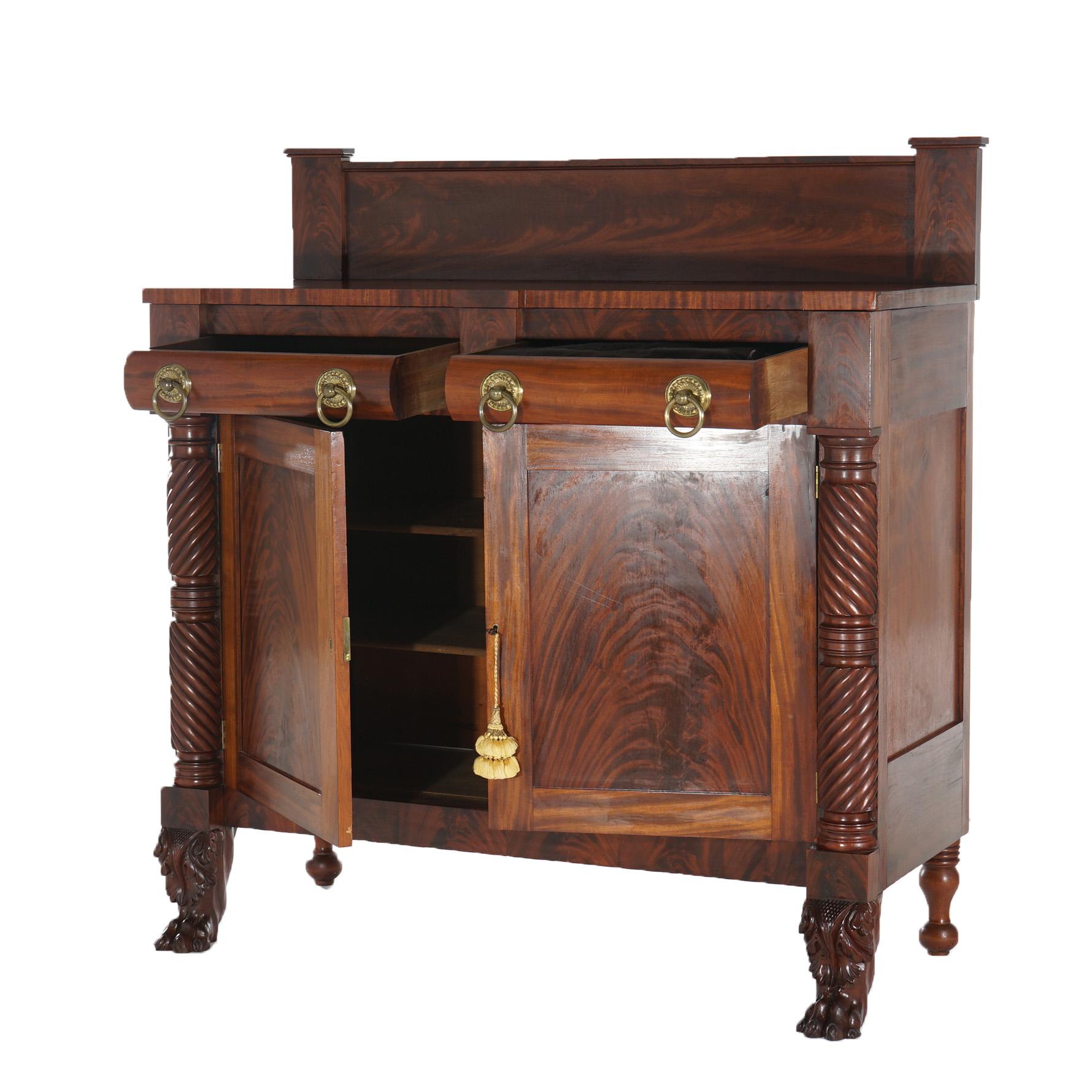 ***Ask About Reduced In-House Shipping Rates - Reliable Service & Fully Insured***
An antique American Empire linen press sideboard offers flame mahogany construction with marble top over case with double drawers and double door cabinet flanked by