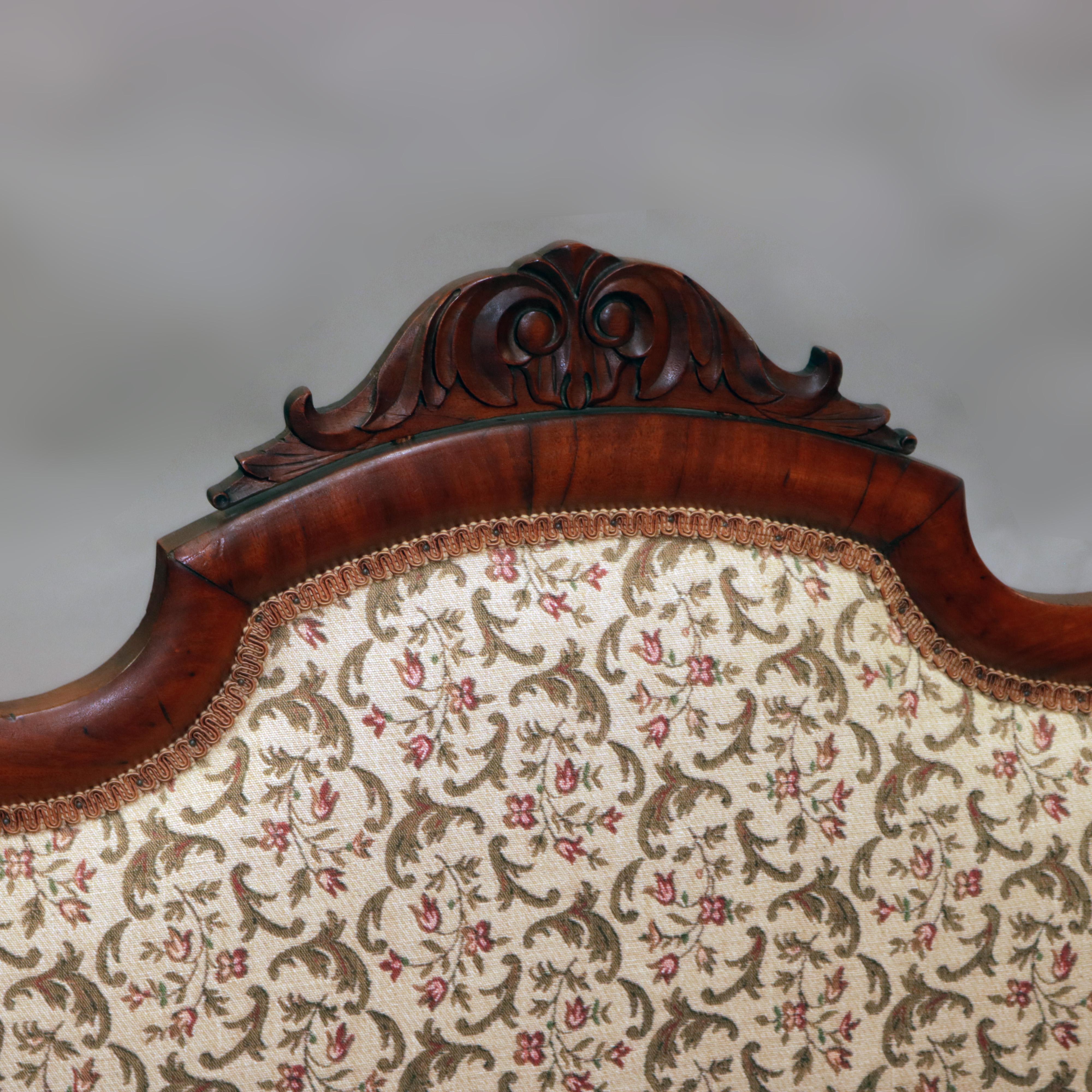 An antique American Empire slipper bench offers flame mahogany frame with shaped back having foliate carved crest and surmounting upholstered back and seat, raised on bracket feet with casters, circa 1850.

Measures: 33.75