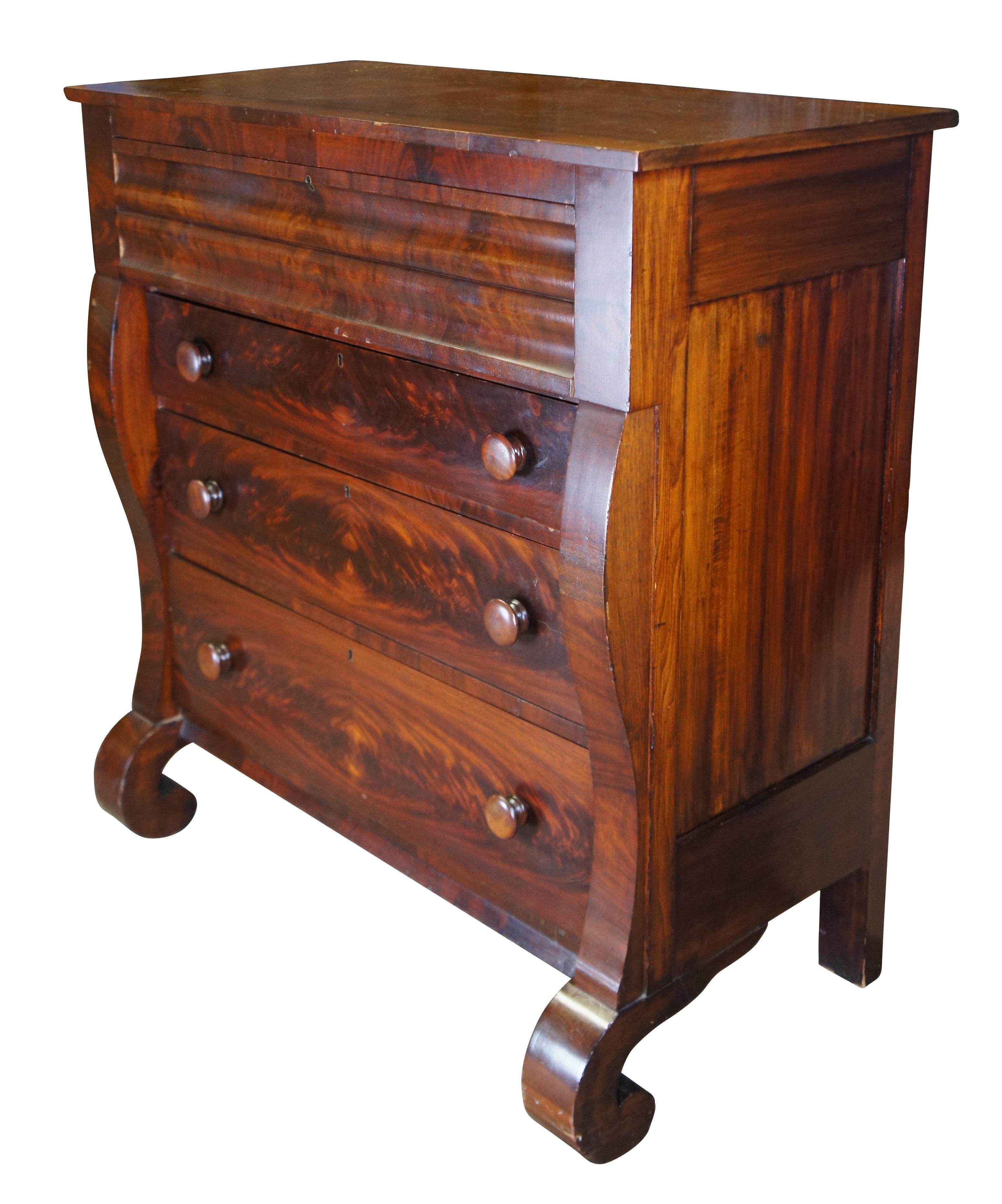 Mid to late 19th century American Empire tallboy / highboy chest. Made of flame / crotch mahognay featuring rectangular form with scrolled front and four hand dovetailed drawers.

Dimensions:
44