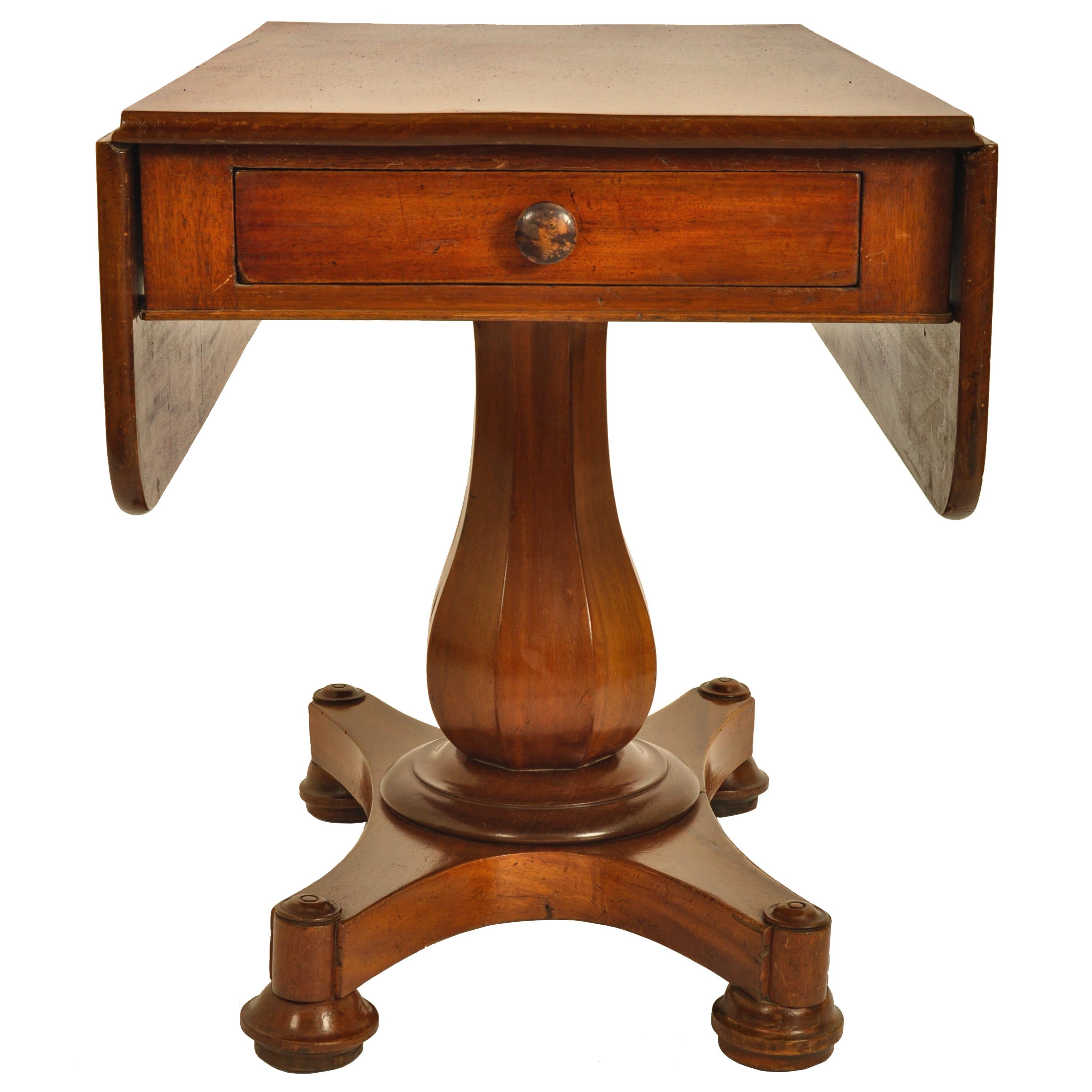 Antique American Classical mahogany drop leaf pedestal Pembroke ccard/tea table attributed John Needles of Baltimore, circa 1840. The table made of figured mahogany with twin drop leaves and a single drawer to the center. The table standing on a