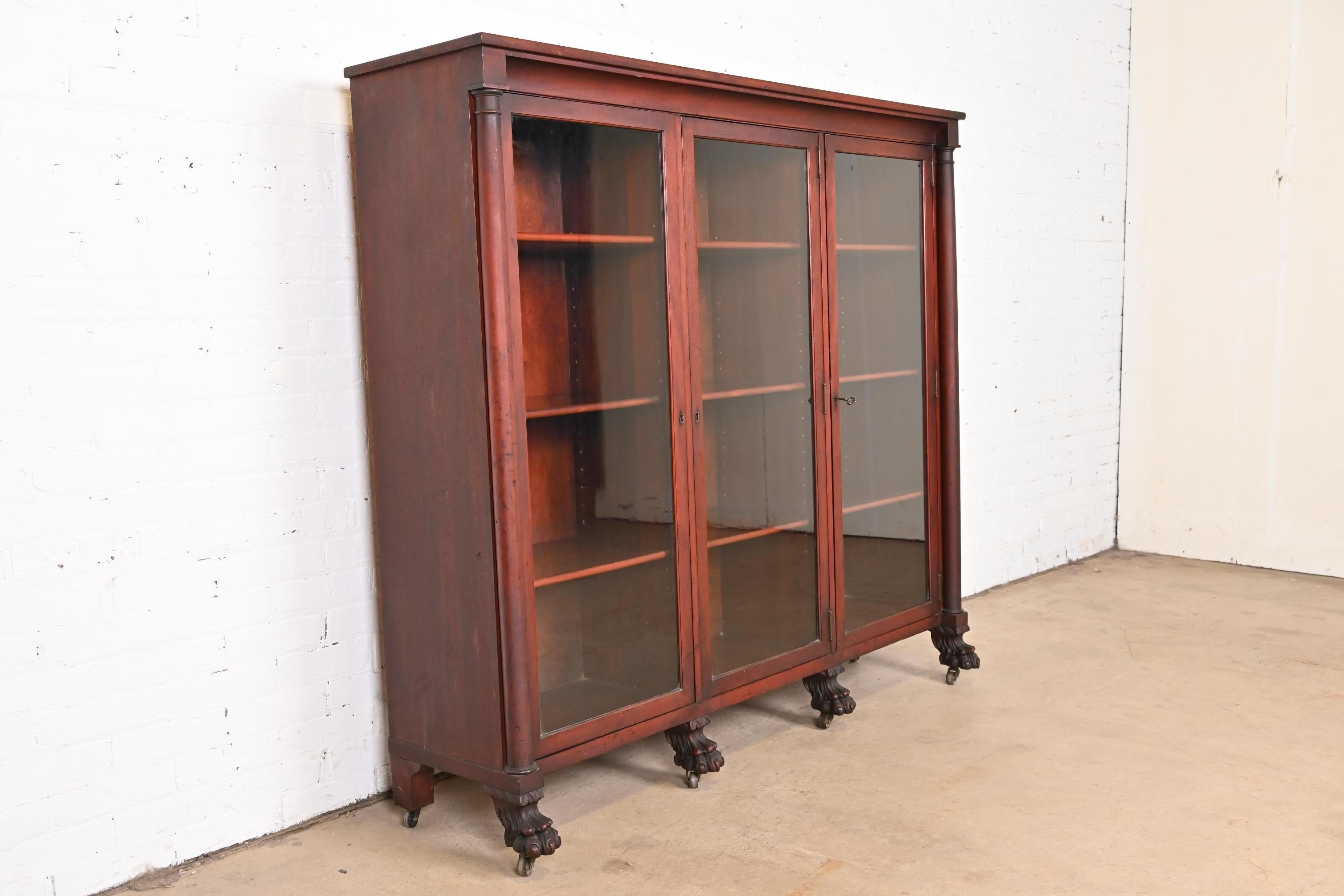 Glass Antique American Empire Mahogany Triple Bookcase with Carved Lion Paw Feet