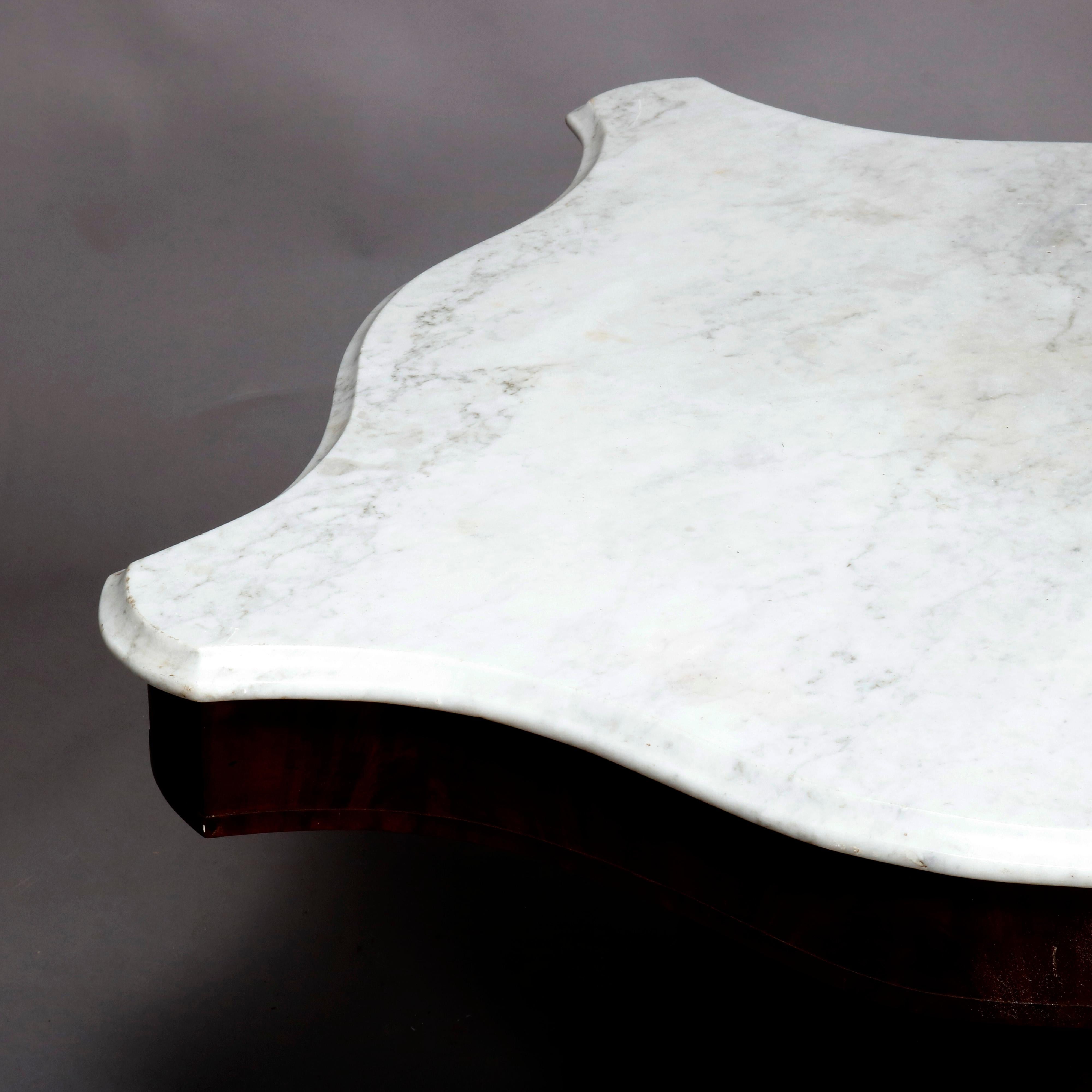 An antique American Empire turtle top center table offers shaped and beveled top surmounting mahogany base with urn form pedestal and raised on shaped feet with casters, circa 1880.


Measures: 28.25