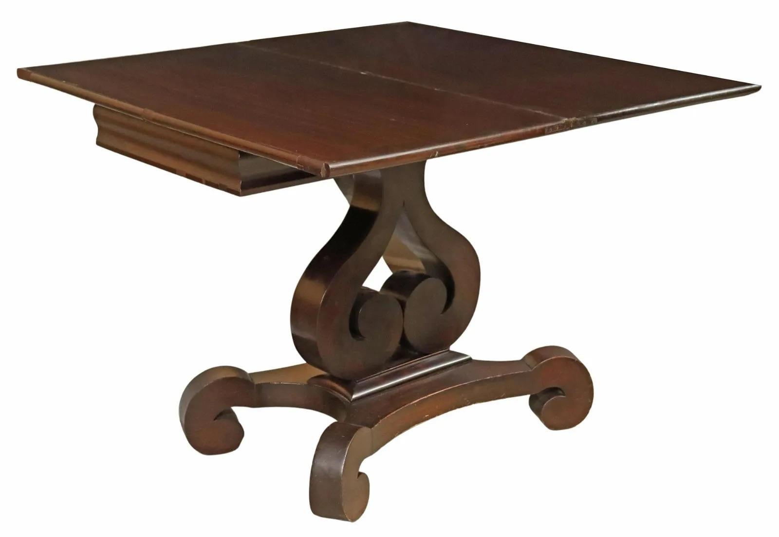 American Empire period mahogany games table, 19th c., having rectangular flip top, over interior compartments, rising on double scroll base, ending on quadripartite scrolled feet.

Dimensions: approx 27.25
