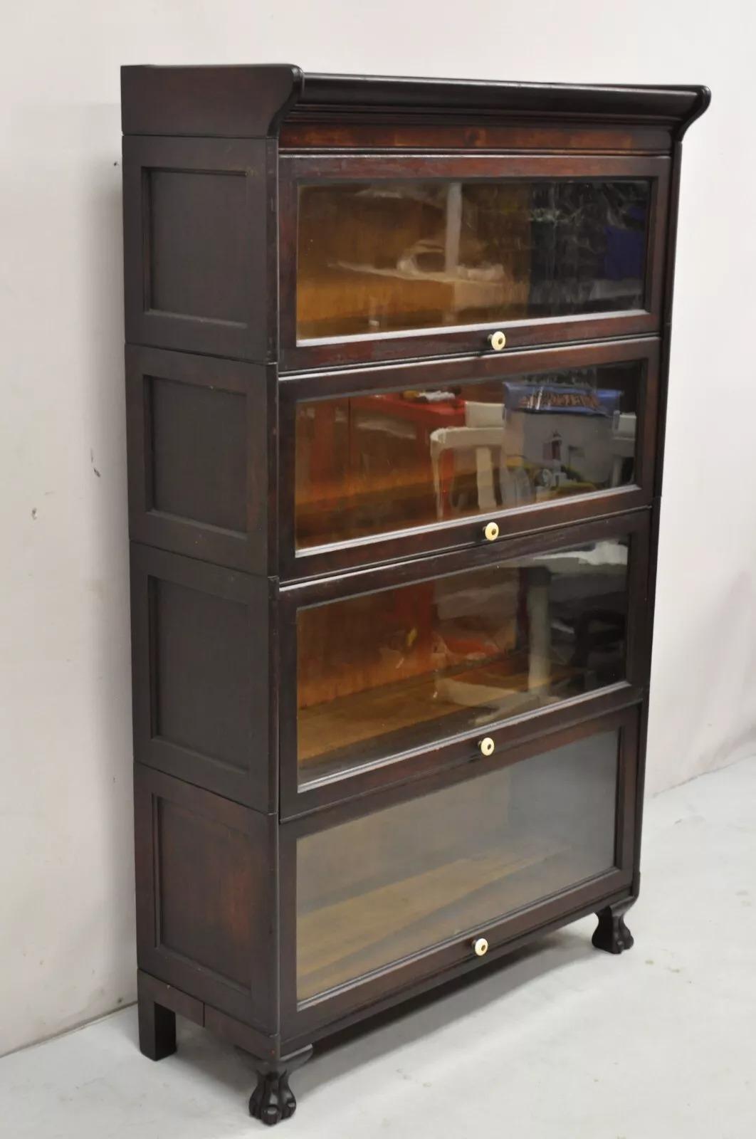 Antique American Empire Style Mahogany 4 Section Stacking Barrister Bookcase. Item features carved paw feet, 4 glass doors, stacking form, very nice antique bookcase. Top 2 sections are 11