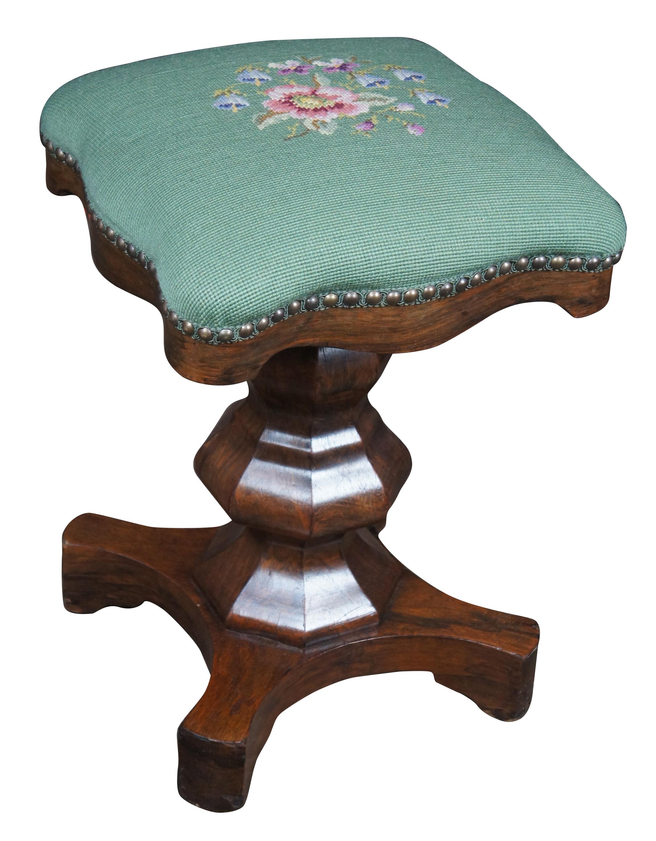 Circa 1850s American Empire Adjustable Piano stool. Features a serpentine seat with a green floral needlepoint embroidered cushion. Classic lines and sturdy construction give this piece timeless appeal.
 