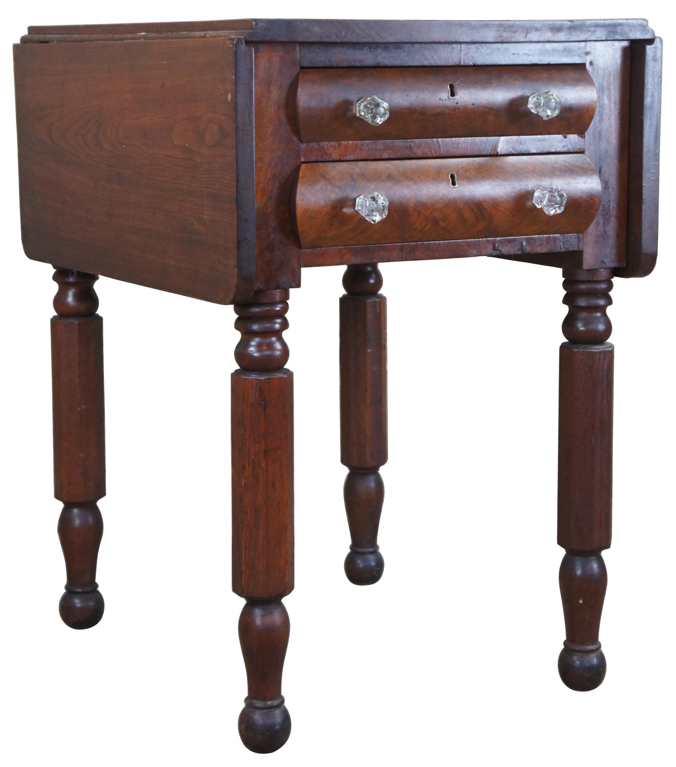 Antique American Federal drop leaf side table. Made of Mahogany featuring two drawers with glass pulls, turned legs and nubby feet.

Width of Leaves - 10