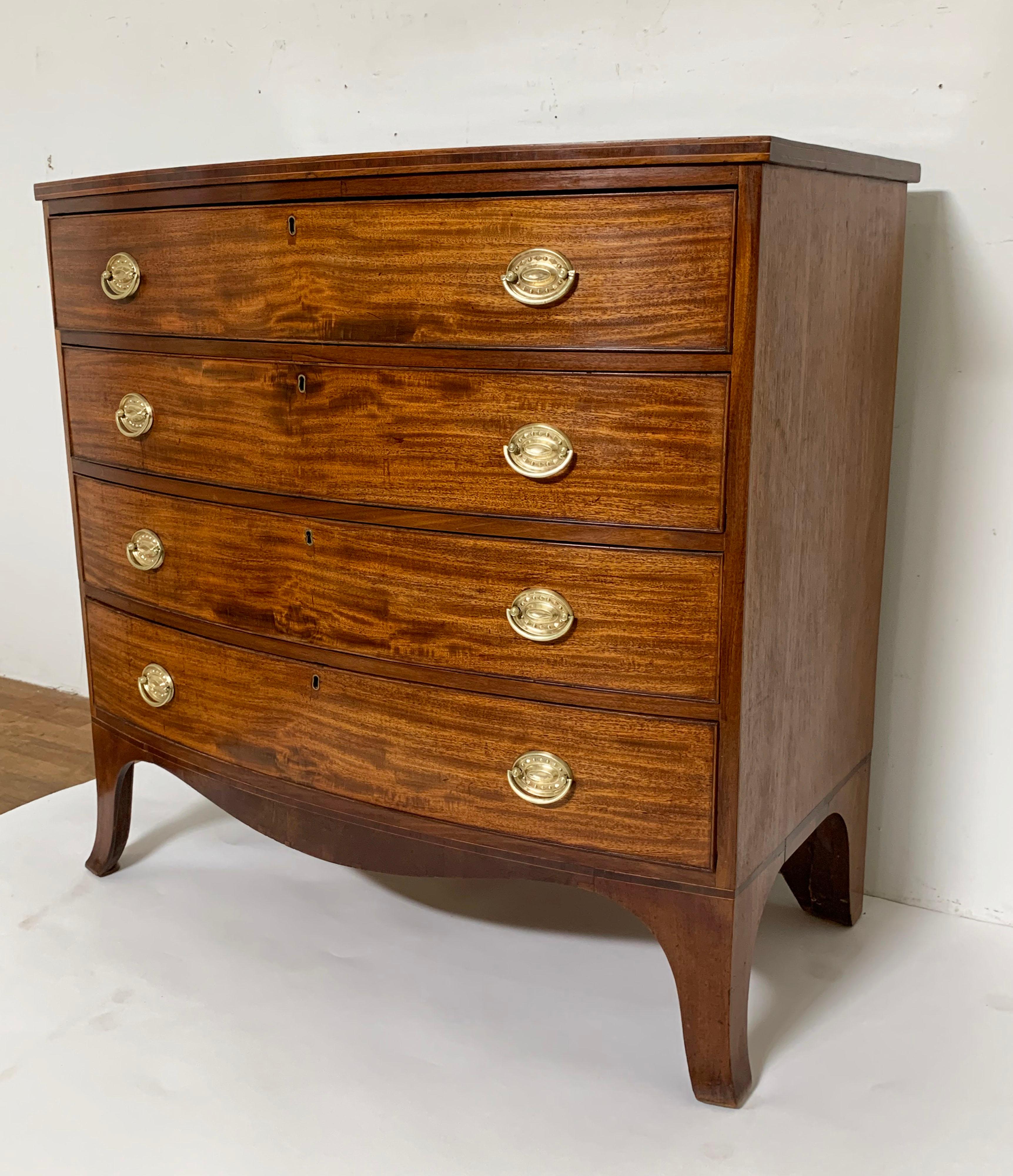 A mahogany four drawer swell front chest, American Federal era, circa 1810-1820, with original brass Hepplewhite pulls and serpentine skirt.
Measures 40.75