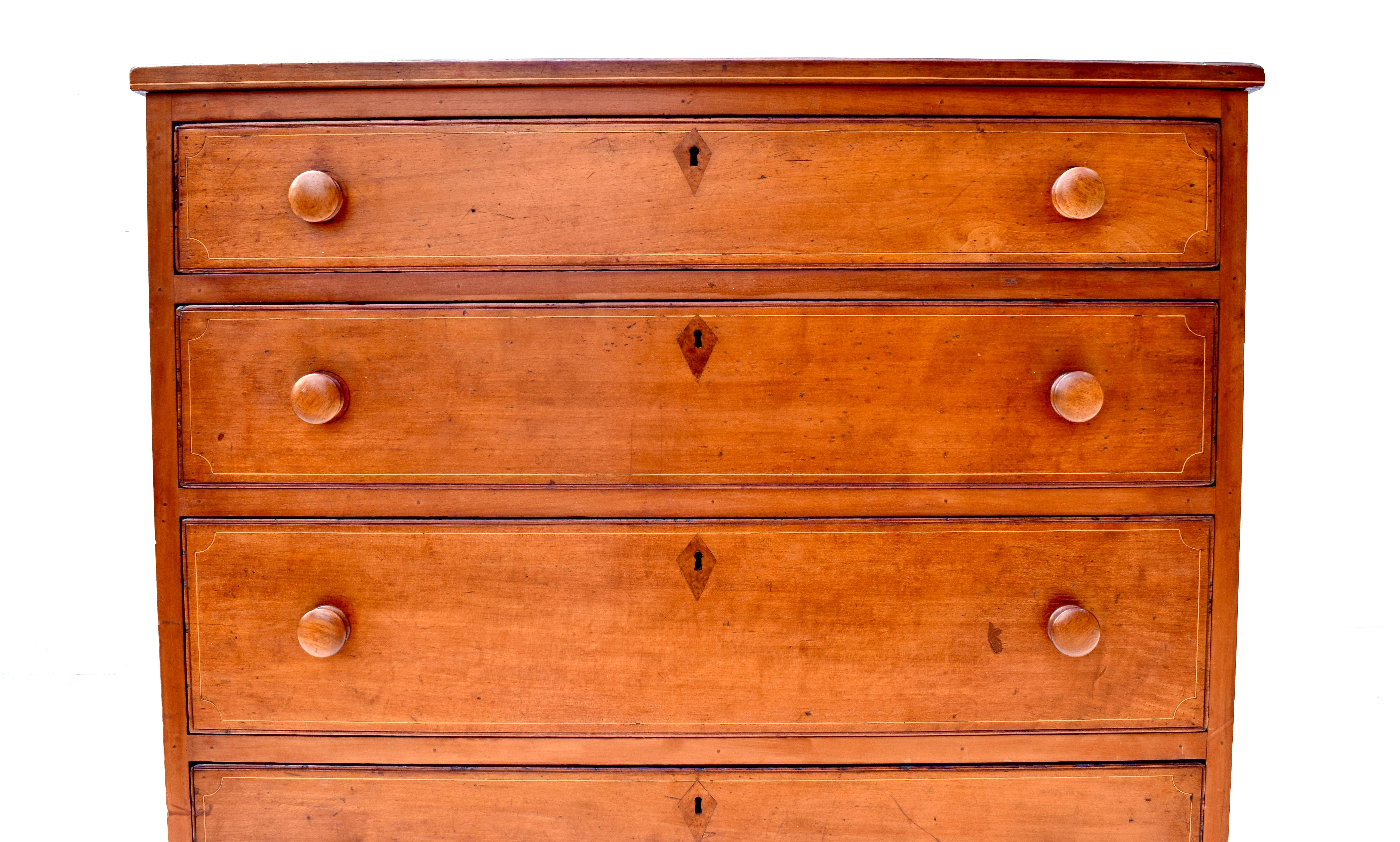 American Federal early 19th century highboy chest with four graduated cockbeaded and dovetailed drawers boasting varying inlays throughout including burl wood diamond keyhole accents. All working & original locks are present. Beautifully maintained