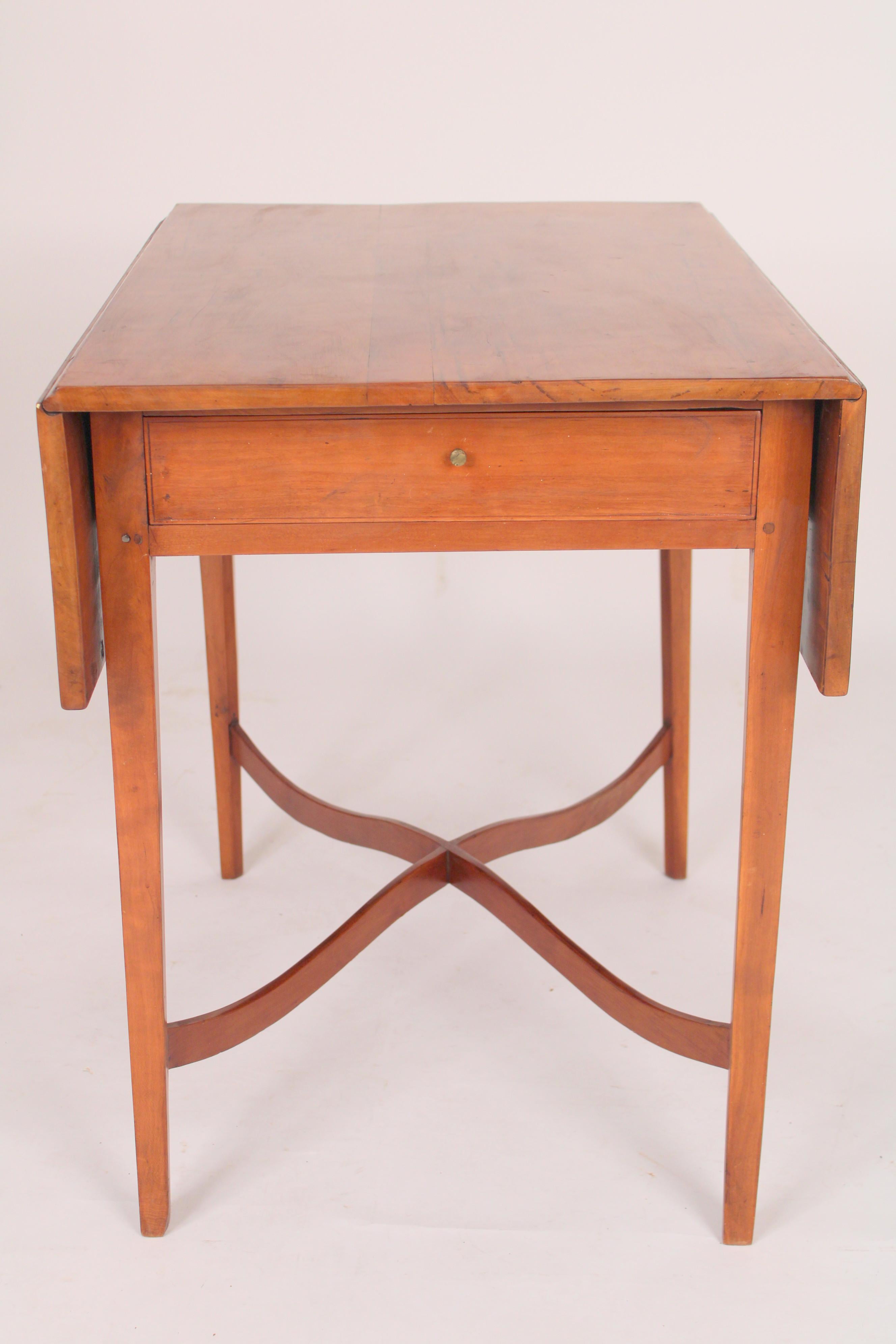 Antique American federal style cherry wood drop leaf table, 19th century. With a 2 board top, a frieze drawer, square tapered legs and S shaped stretcher bars. Nice old cherry wood color and hand dove tailed drawer construction . Dimensions of top