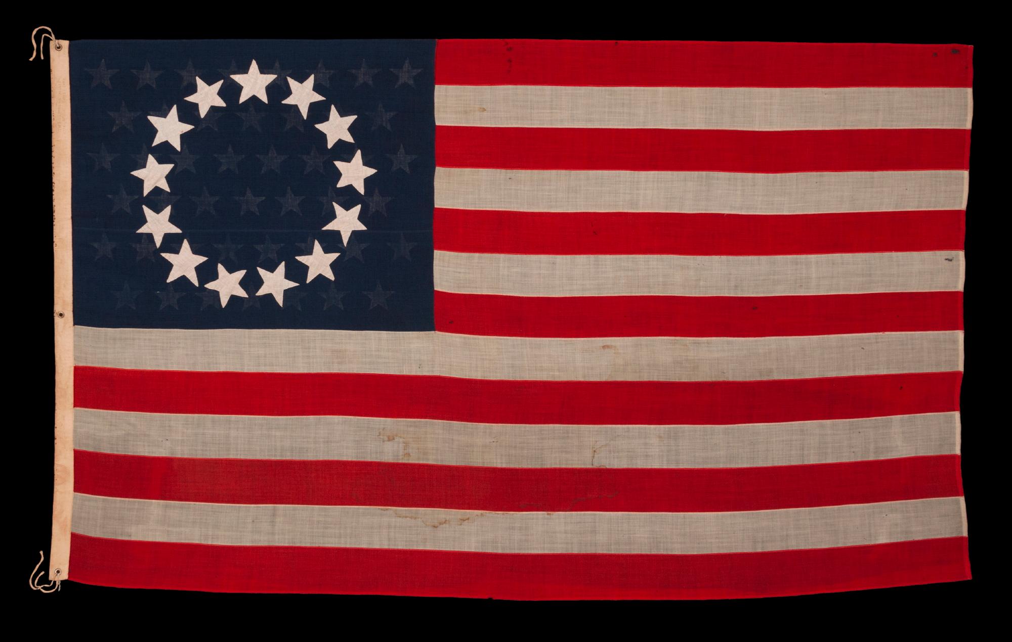 13 STARS IN THE BETSY ROSS PATTERN, WITH 45 STARS ON THE REVERSE;  ON AN ANTIQUE AMERICAN FLAG MADE AND SIGNED BY A PREVIOUSLY UNIDENTIFIED FLAG-MAKER, ANNIE MAC LACHLAN OF JERSEY CITY, NEW JERSEY, circa 1896-1908;  A RARE AND INTERESTING EXAMPLE,
