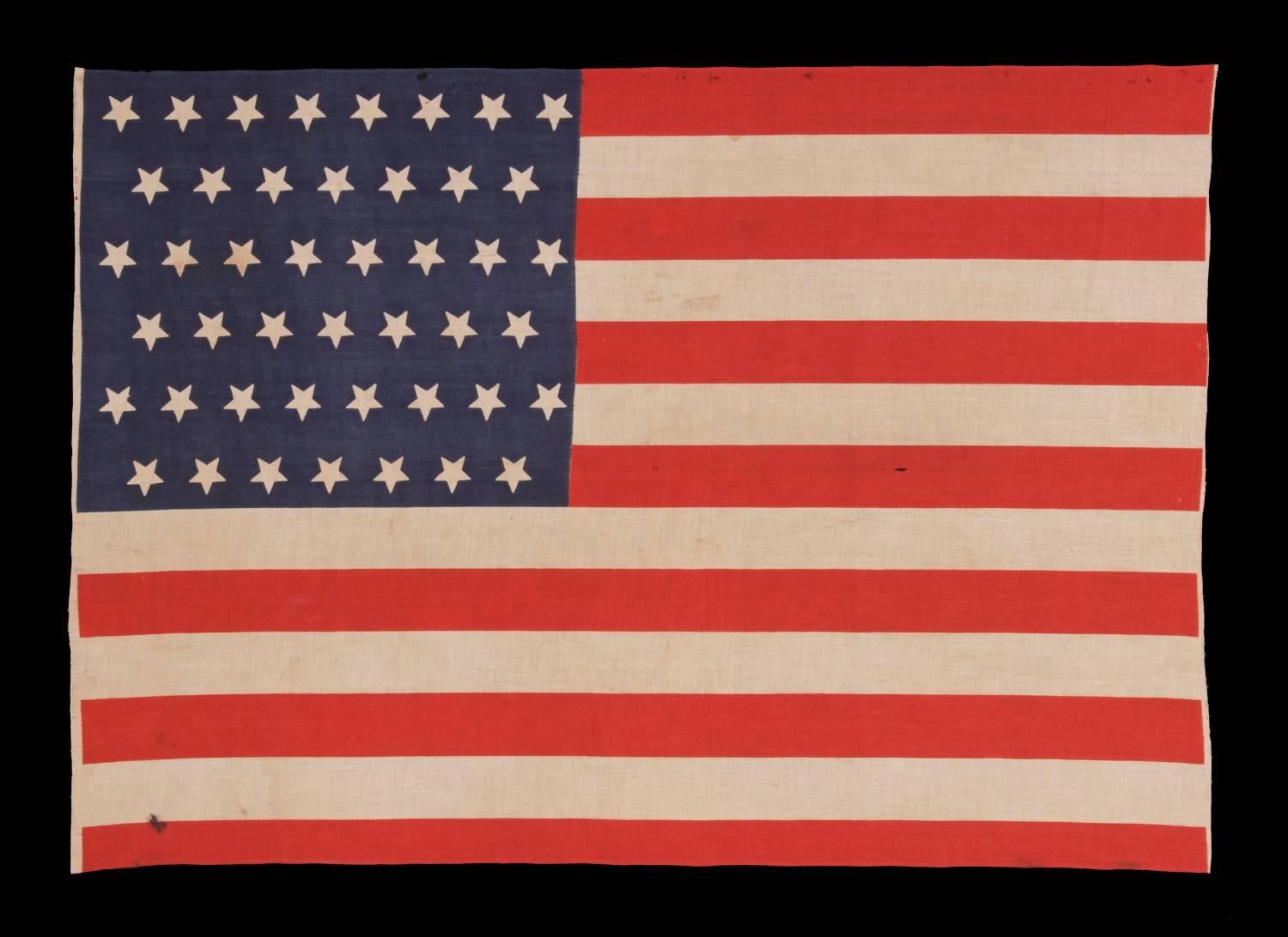 Antique American flag with 45 upside-down stars, 1896-1908, utah statehood, Spanish-American war era:

45 star American national parade flag, printed on plain weave cotton. Note how the stars, which are arranged in staggered rows, are upside-down