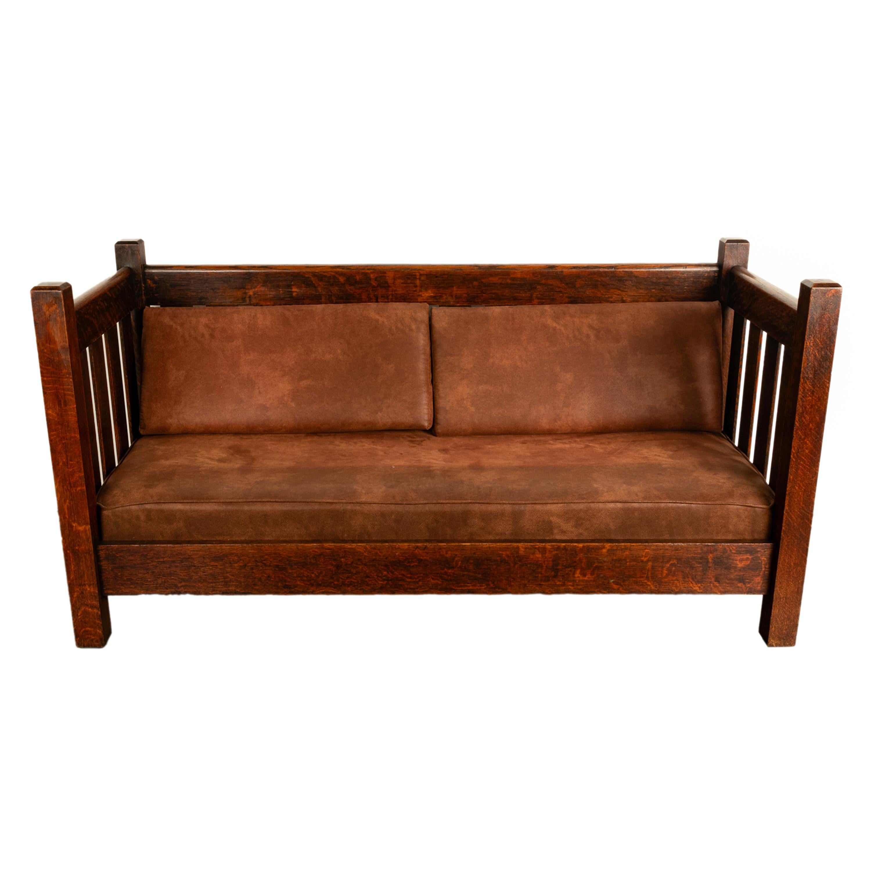 A good antique Early Gustav Stickley #173 even arm mission oak bungalow settle 1902.
The settle is made from quarter sawn oak & having slats to the sides and back,  the base and back having newly made ultra suede cushions. Seems  to be unsigned,