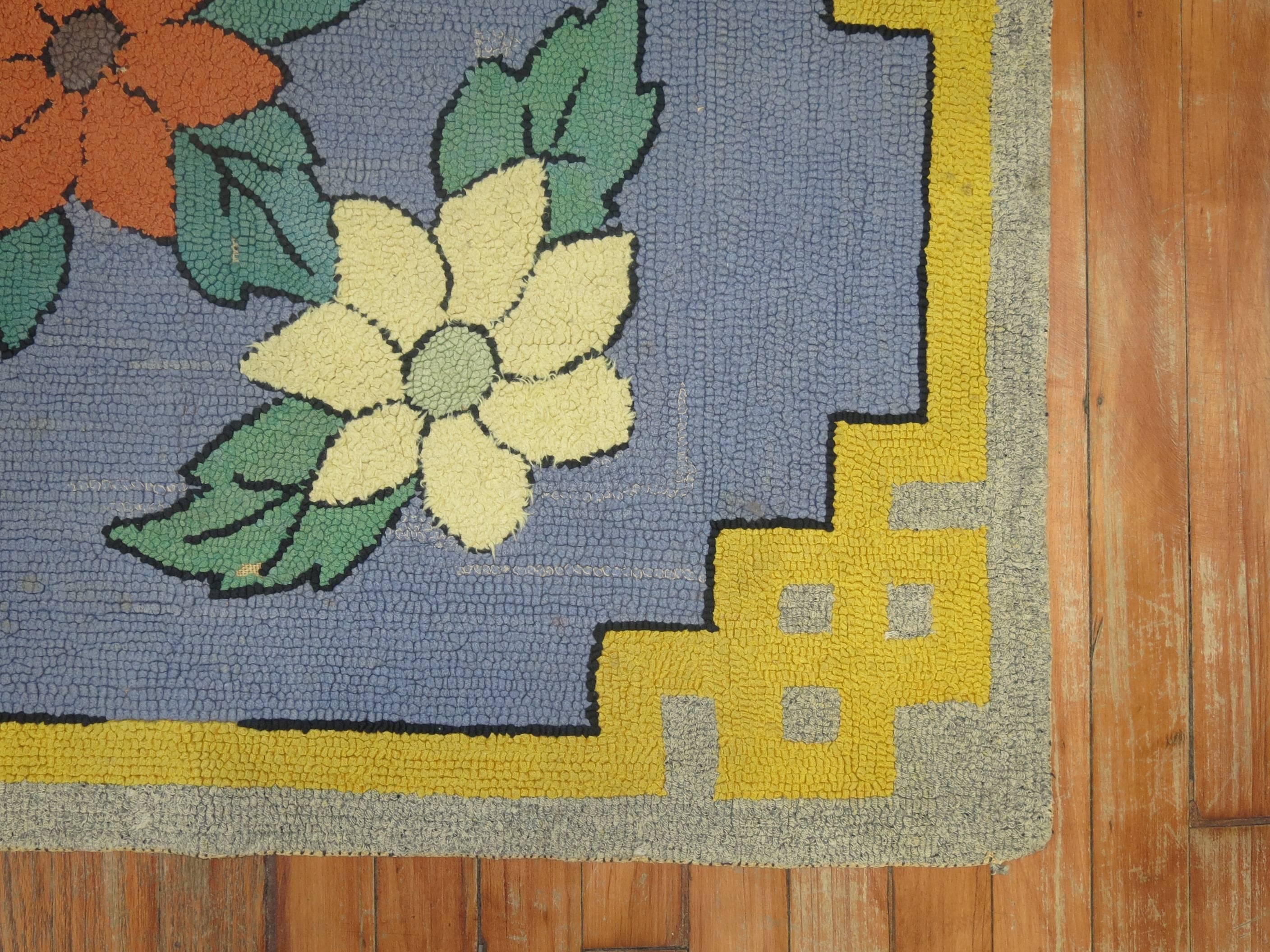 An American hooked rug from the early part of the 20th century with a fresh, colorful floral design. Colors are quite eye-catching.